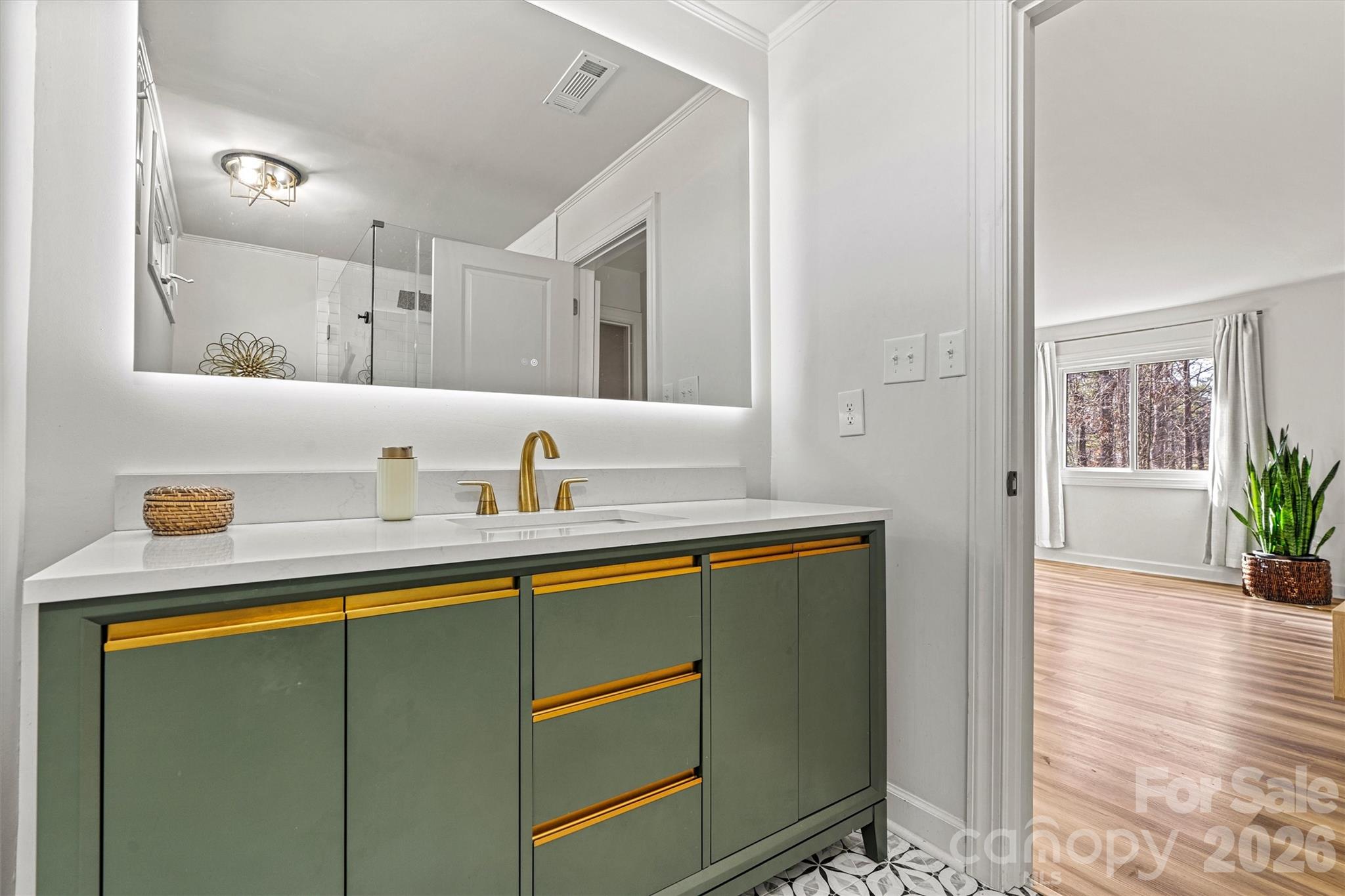 Primary ensuite bath, gorgeous flooring and vanity - 3995 Burton Lane, Denver