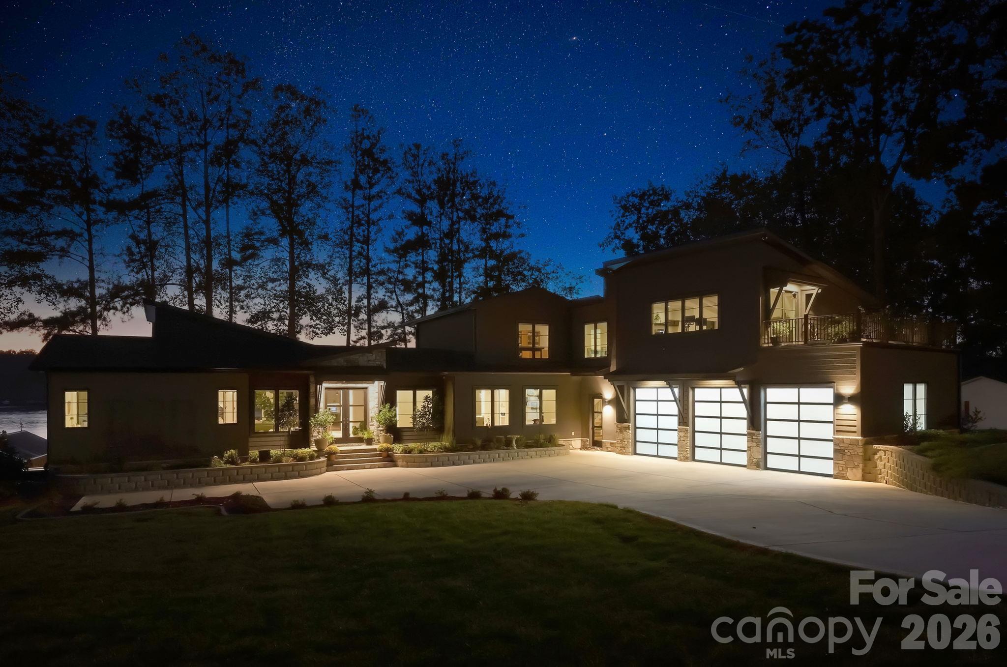 Front exterior at night. Gorgeous lighting shows off the architectural lines of the property - 298 Marietta Road, Mooresville