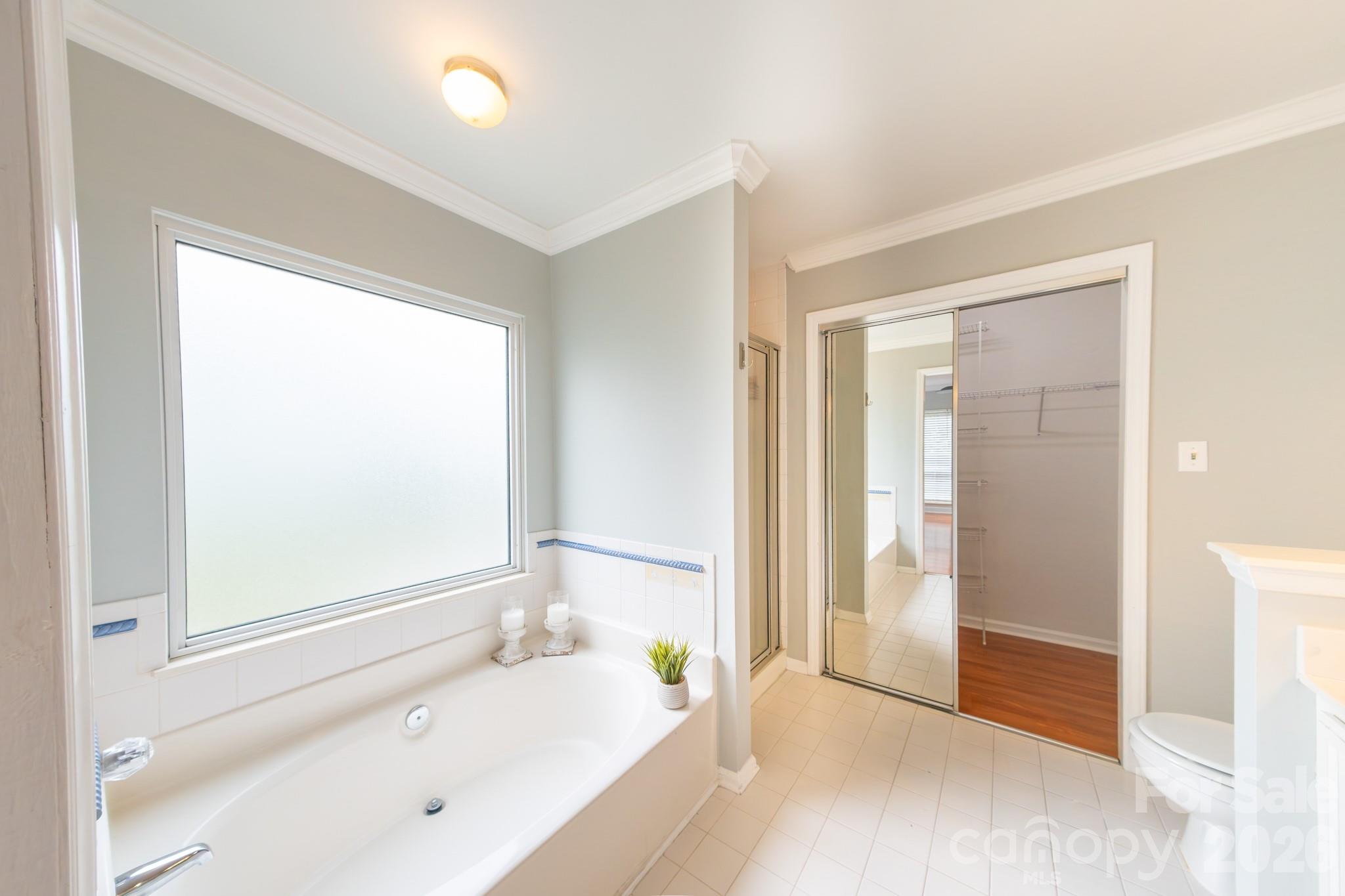 En-suite bathroom with garden tub and shower - 13836 Poppleton Court, Charlotte