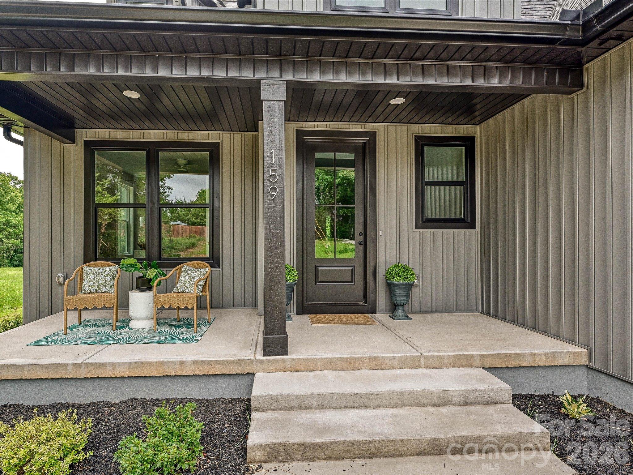 Charming covered front porch welcomes you with modern finishes, stylish seating & the perfect space to relax & enjoy the peaceful surroundings. - 159 Lone Pine Road, Statesville