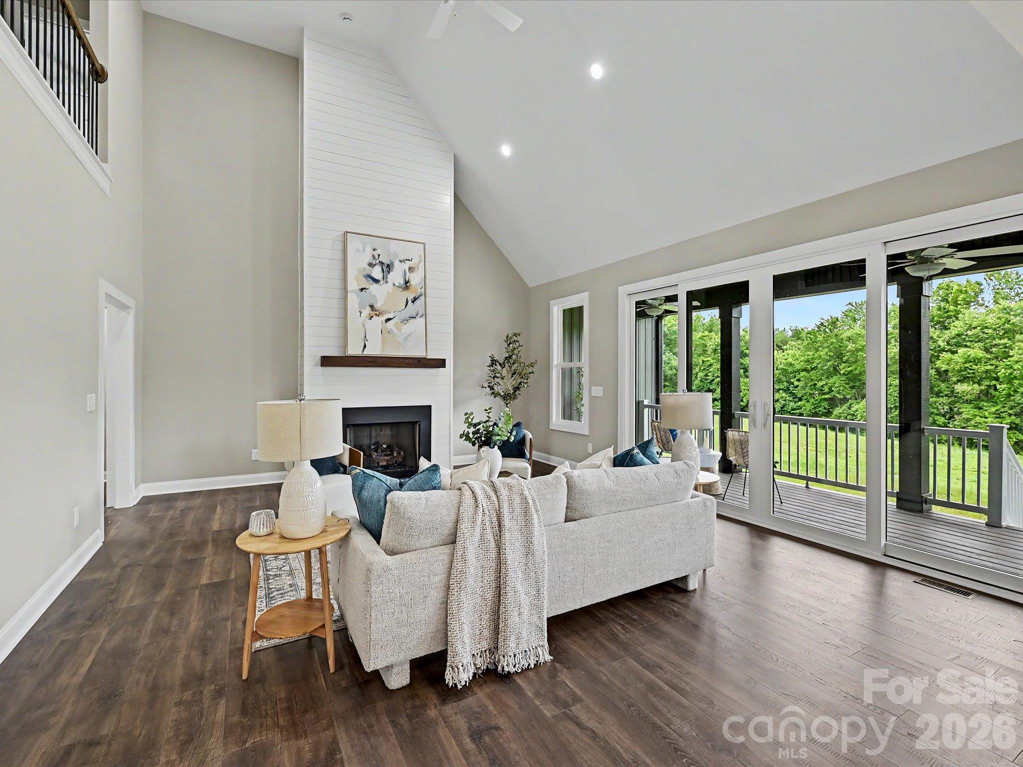 The stunning great room showcases soaring vaulted ceilings, expansive windows with scenic views, cozy gas fireplace & an open concept layout that seamlessly connects the living, dining & kitchen spaces for effortless entertaining. - 159 Lone Pine Road, Statesville