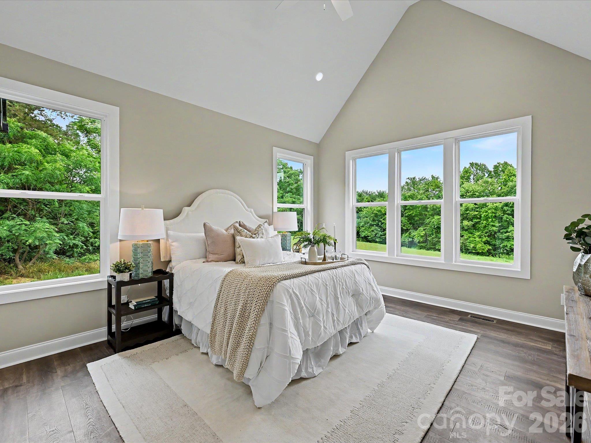 Spacious primary suite features soaring vaulted ceilings, abundant natural light & peaceful views of the private back yard. - 159 Lone Pine Road, Statesville