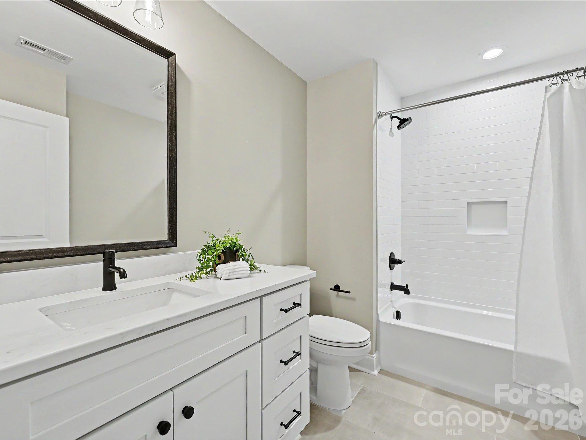 Stylish full bath on upper level features modern finishes, a sleek vanity & a tiled tub/shower combination. - 159 Lone Pine Road, Statesville