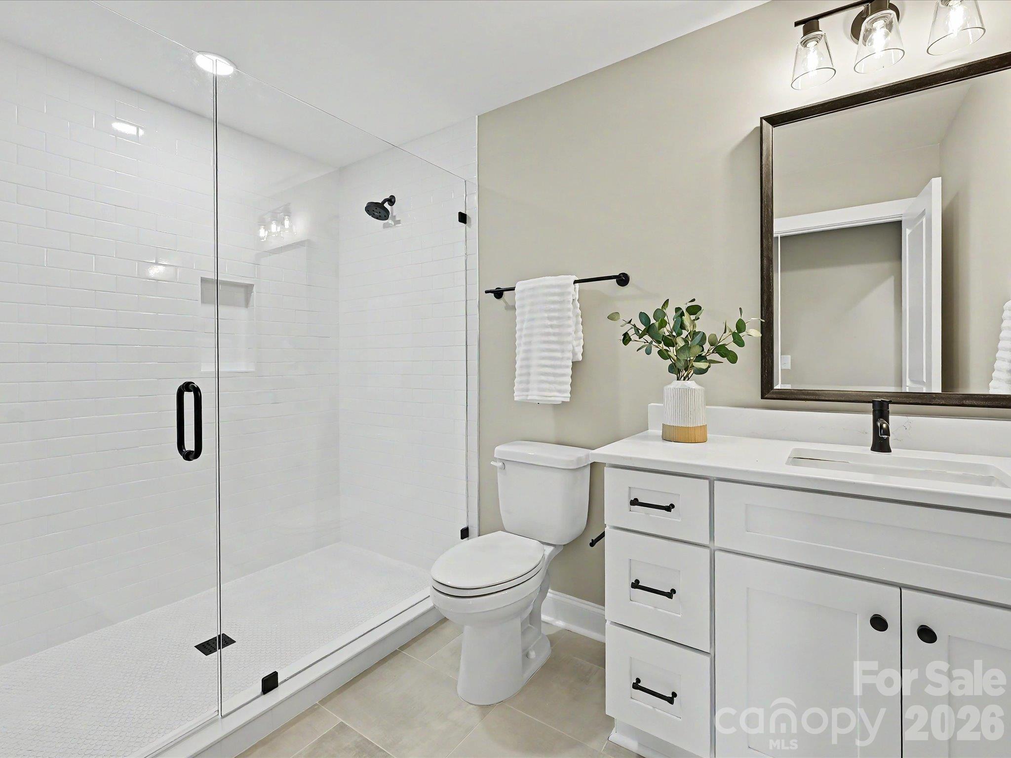 Modern third full bath on upper level features a sleek glass enclosed tile shower, contemporary fixtures & stylish finishes throughout. - 159 Lone Pine Road, Statesville