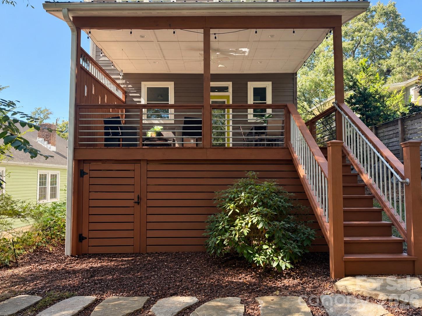 AI inspiration of what someone could do under the covered deck to create more storage. - 84 Middlemont Avenue, Asheville