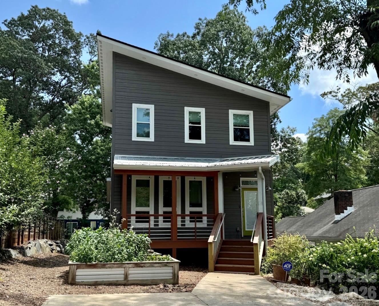 Image shows when sellers lived in the home and had raised garden beds in front - 84 Middlemont Avenue, Asheville