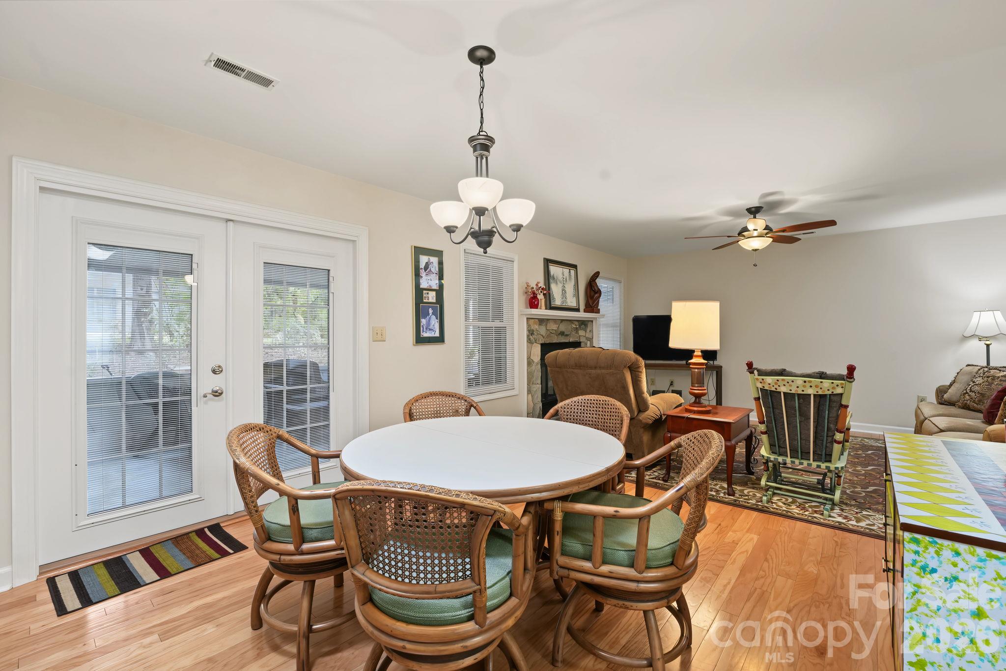 Dining area with view into living room and screened porch - 420 English Ivy Court, Fort Mill