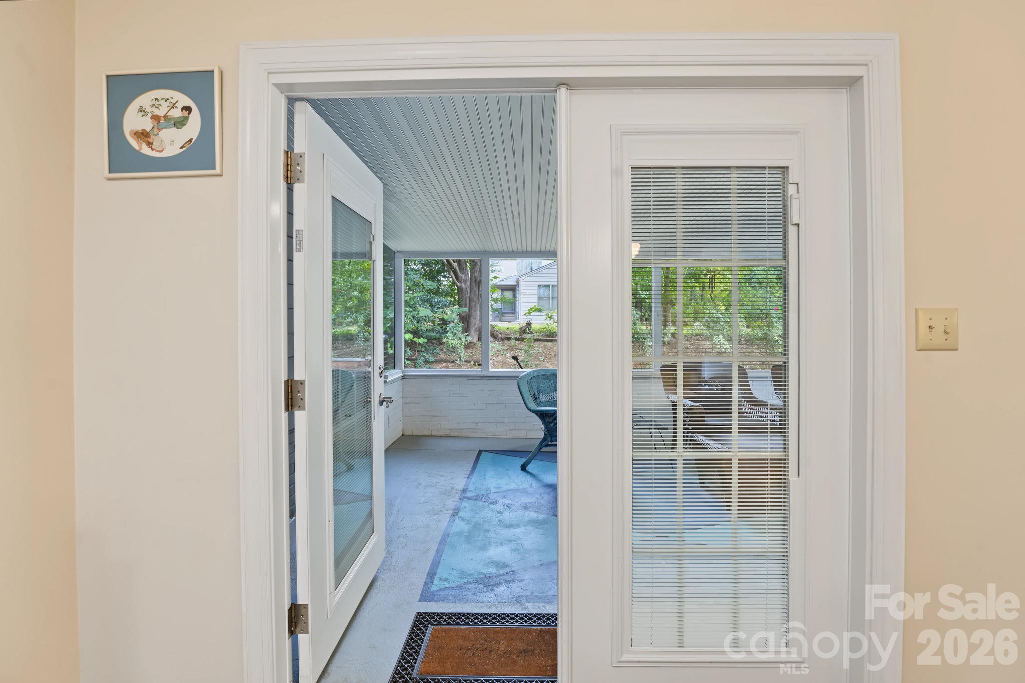 French doors with built in blinds leading to screened porch - 420 English Ivy Court, Fort Mill