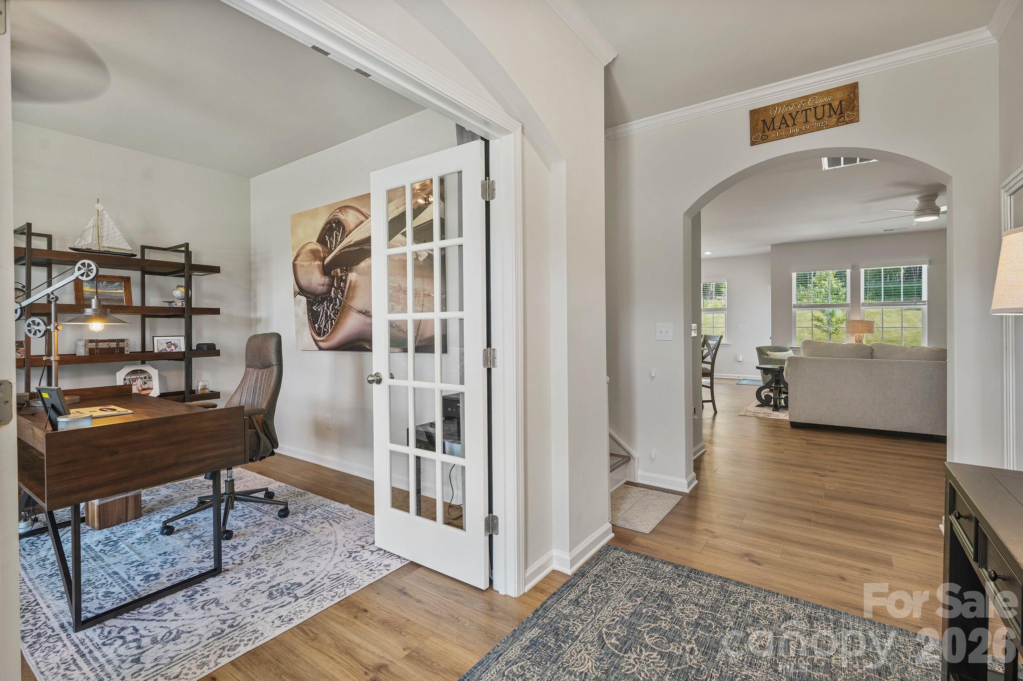 Welcoming entryway featuring a private home office with elegant glass French doors. - 107 Hollywood Court, Troutman