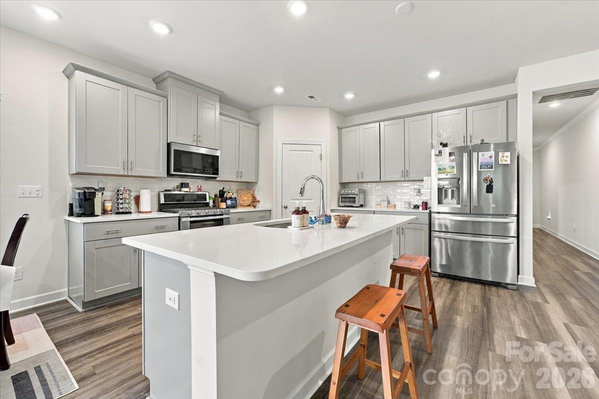 2nd view of the kitchen with quart countertops and stainless appliances. - 7722 Porrera Street, Charlotte