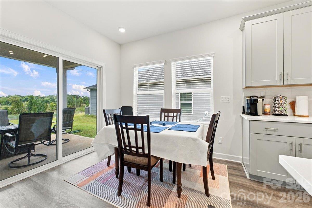 Dining area off the kitchen with slider doors to the covered back porch. - 7722 Porrera Street, Charlotte