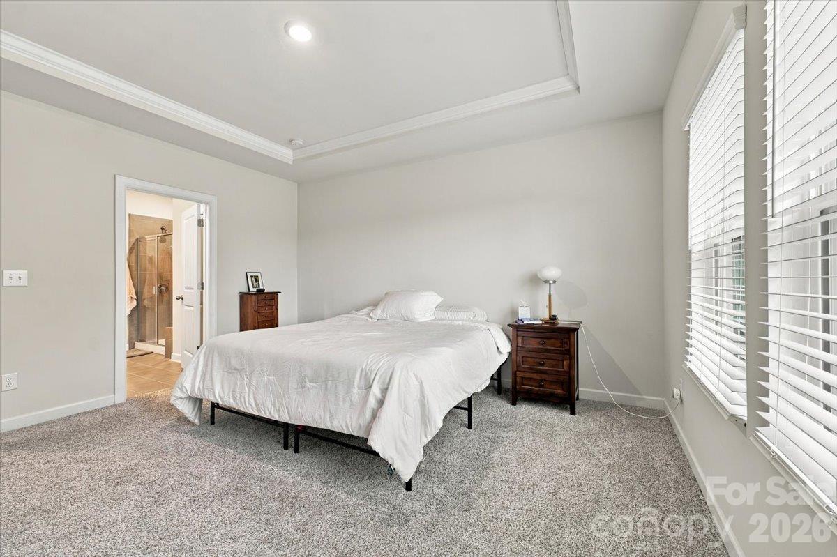 Primary bedroom with trey ceiling detail. - 7722 Porrera Street, Charlotte