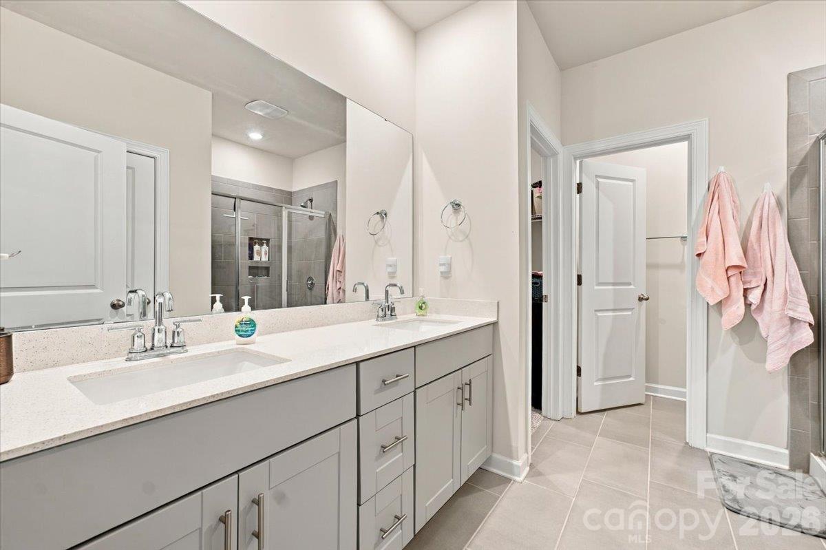 Primary bathroom with dual sink vanity. - 7722 Porrera Street, Charlotte