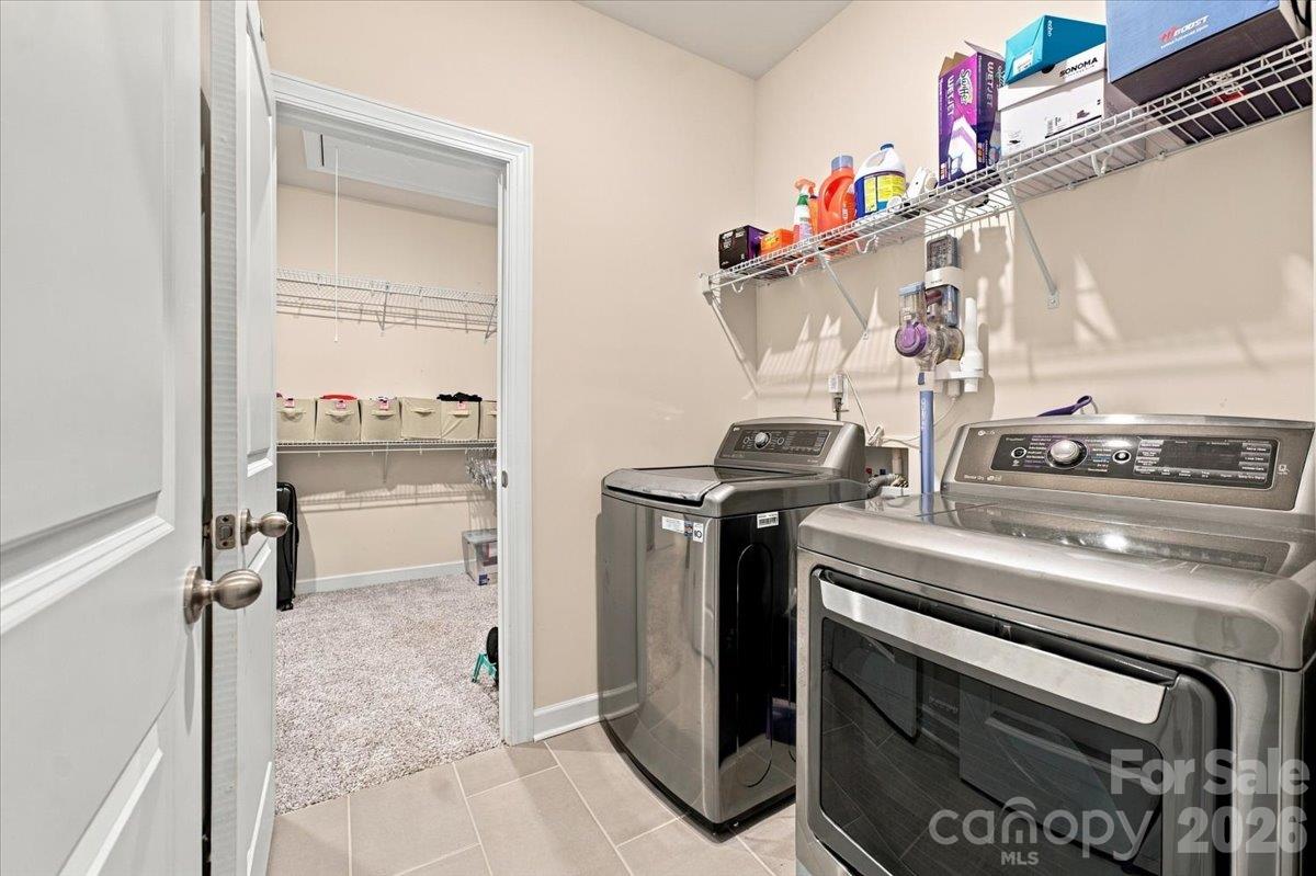 Large laundry room with direct access from the primary closet. - 7722 Porrera Street, Charlotte