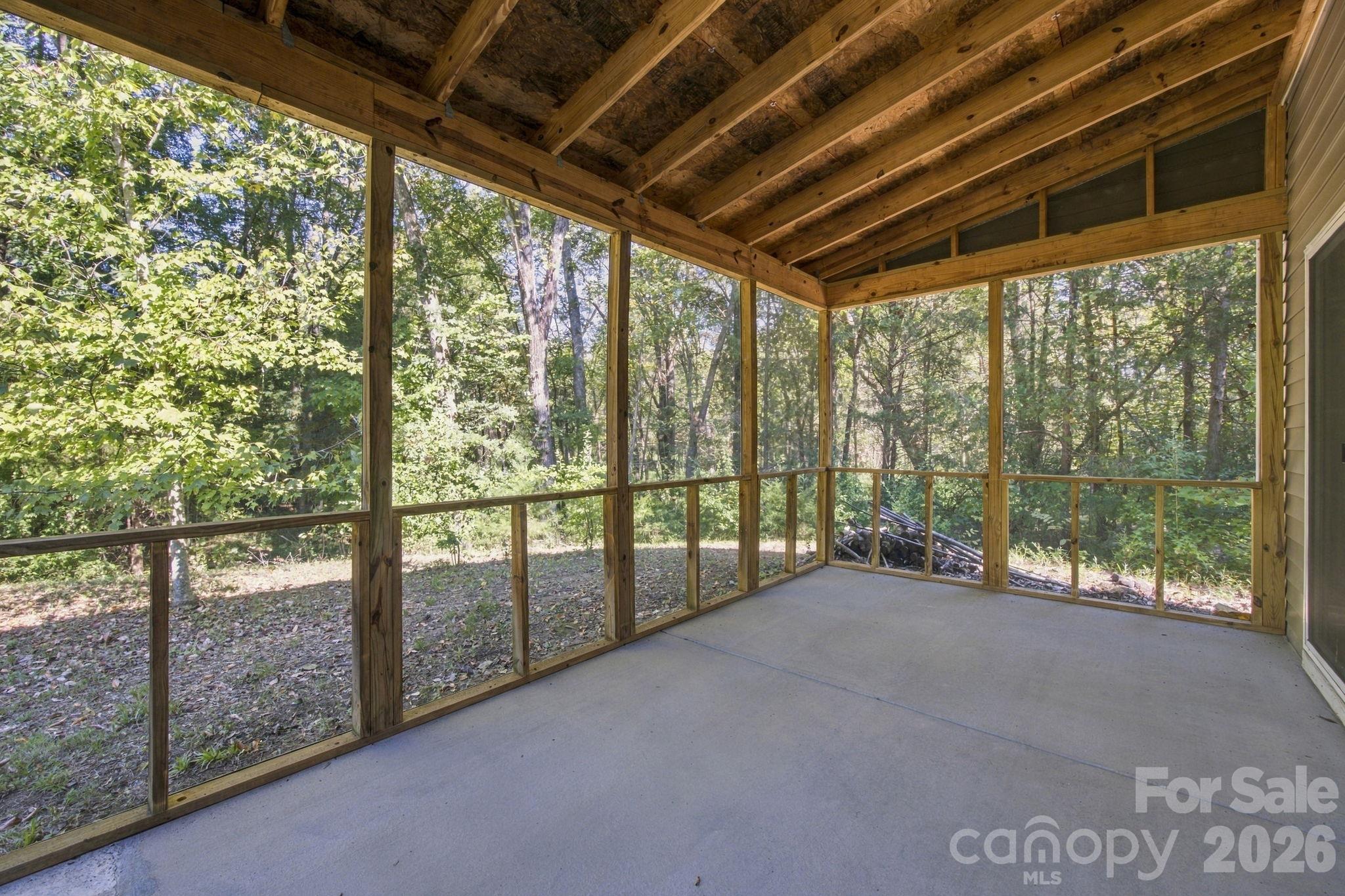 Screened porch looking into your wooded backyard - 11604 Ragan Elizabeth Court, Charlotte