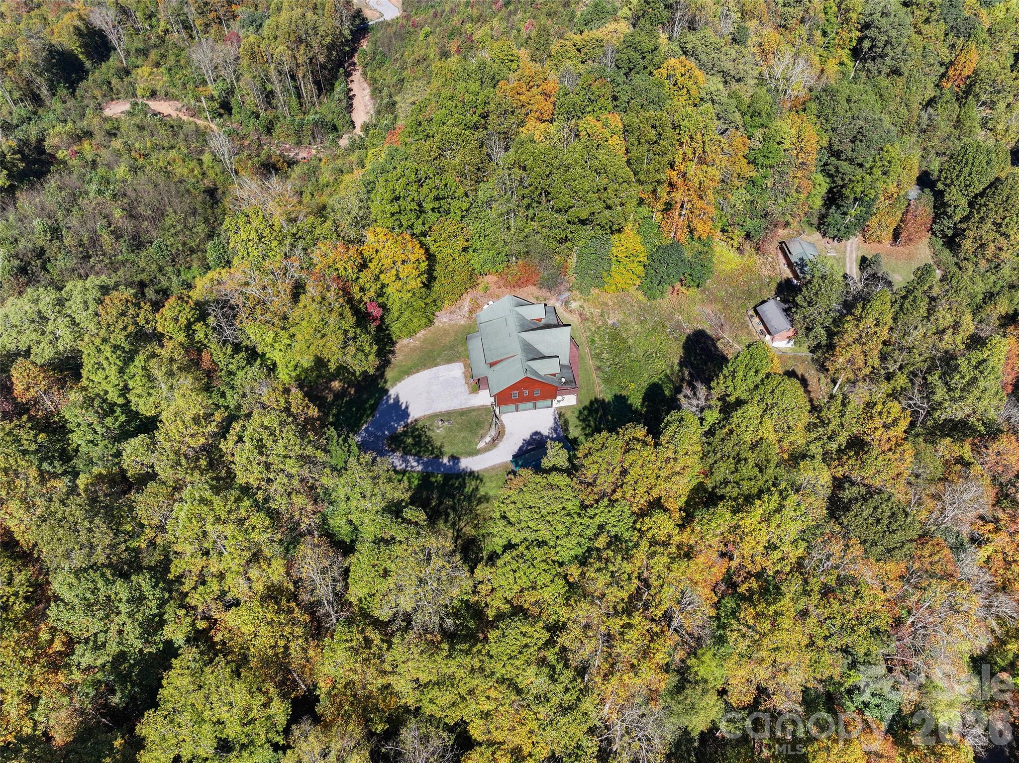 Bird's-eye view of the home tucked among mature hardwoods. - 124 Borges Lane, Waynesville