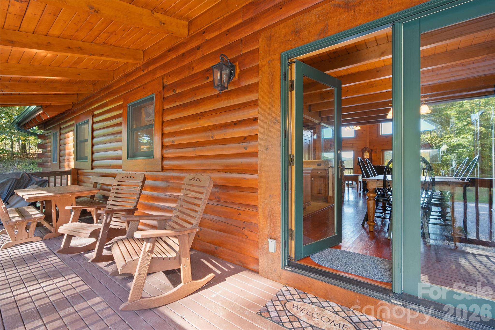 Covered deck offers a peaceful setting to enjoy the outdoors. - 124 Borges Lane, Waynesville