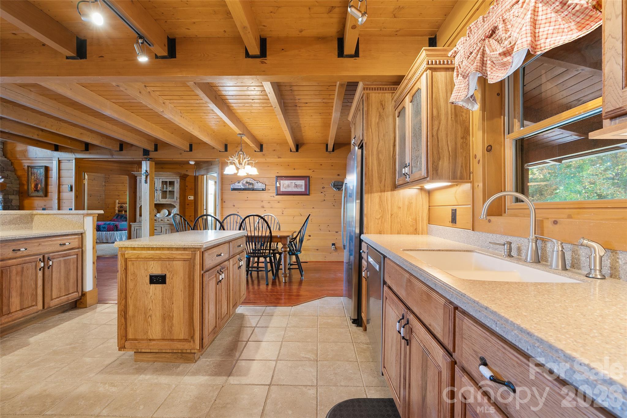 Well-appointed kitchen with center island, abundant cabinetry, and generous workspace. - 124 Borges Lane, Waynesville