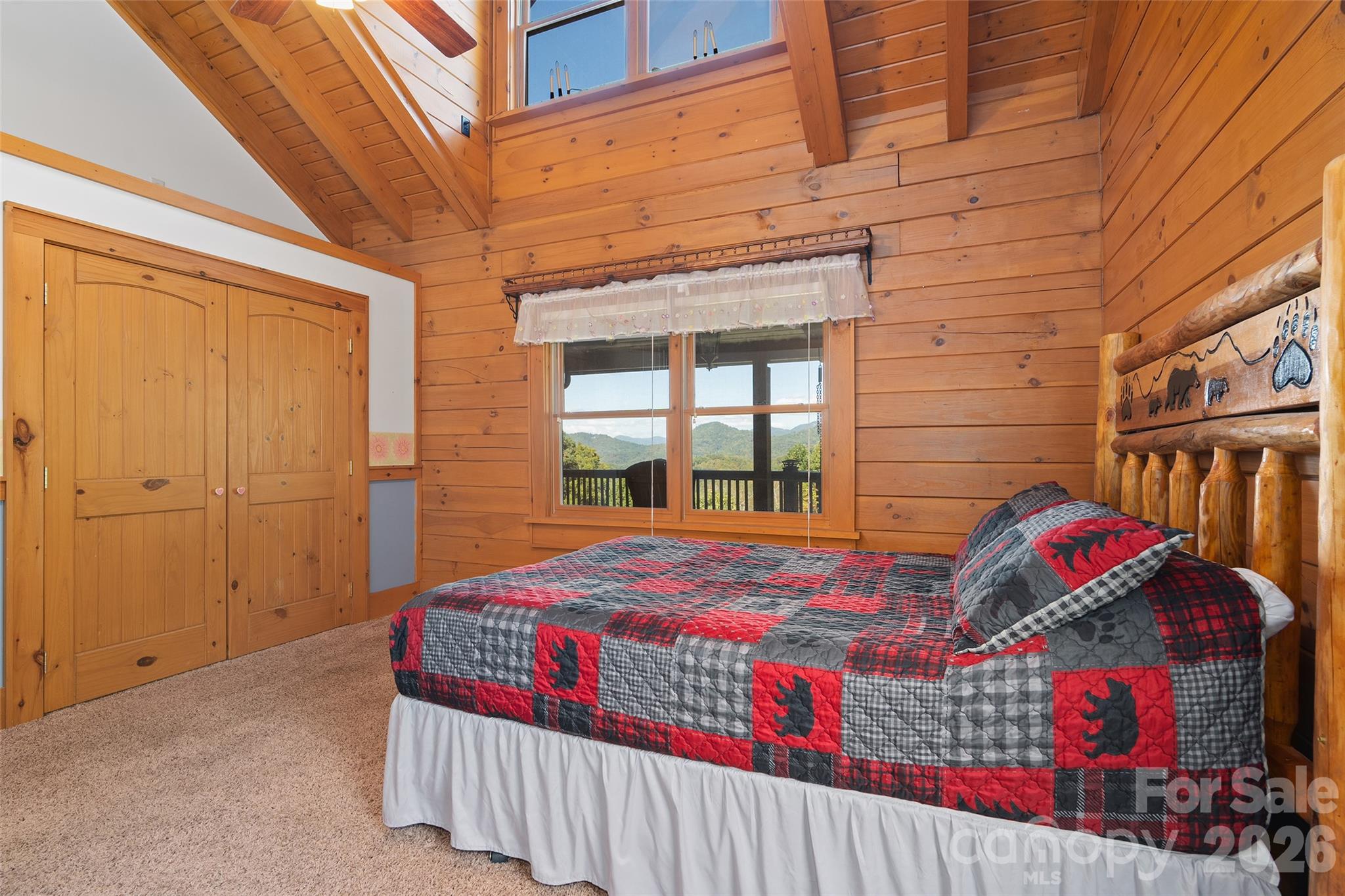 Comfortable main-level bedroom with vaulted ceiling and rustic mountain charm. - 124 Borges Lane, Waynesville