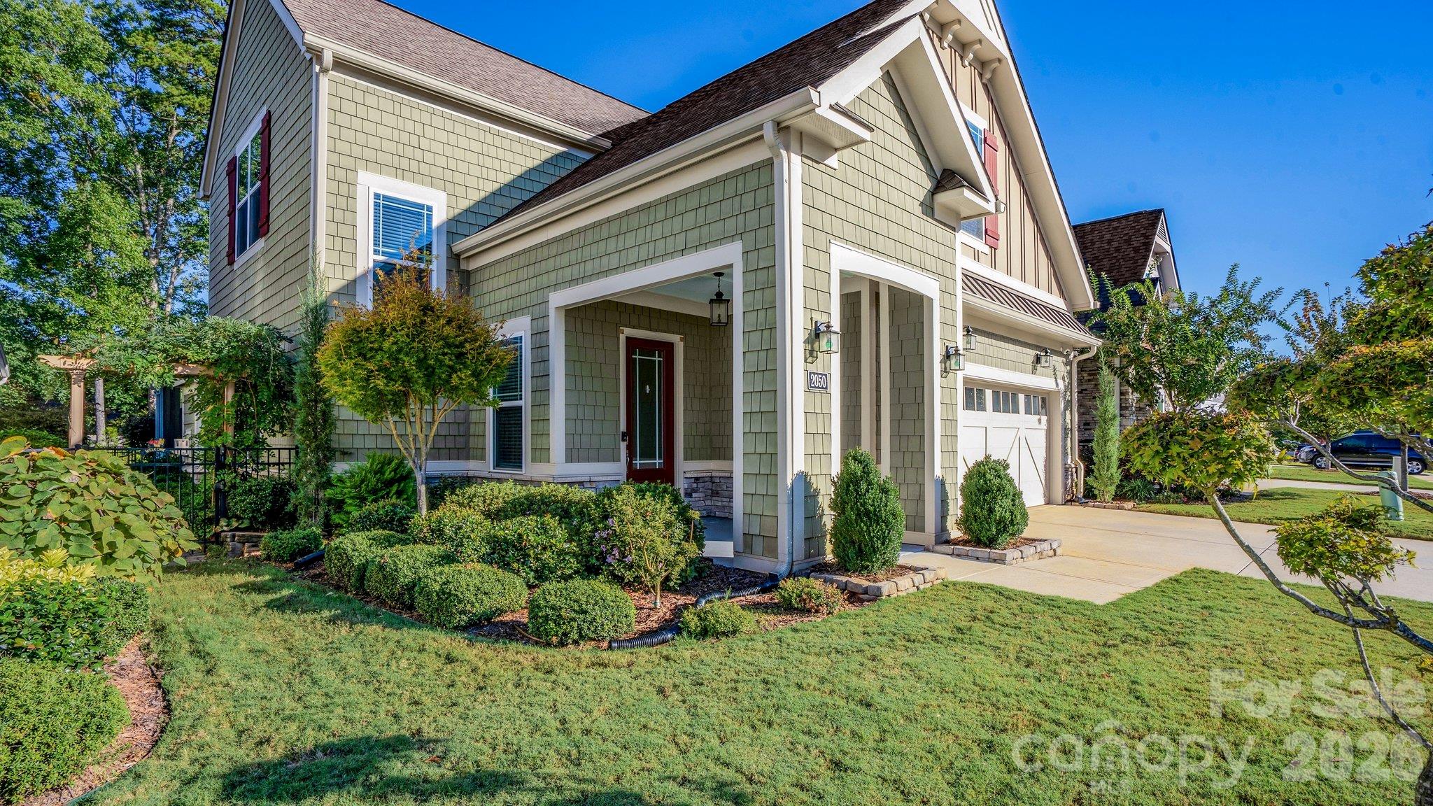 Beautifully landscaped front yard and covered front porch - 2050 Laney Pond Road, Matthews
