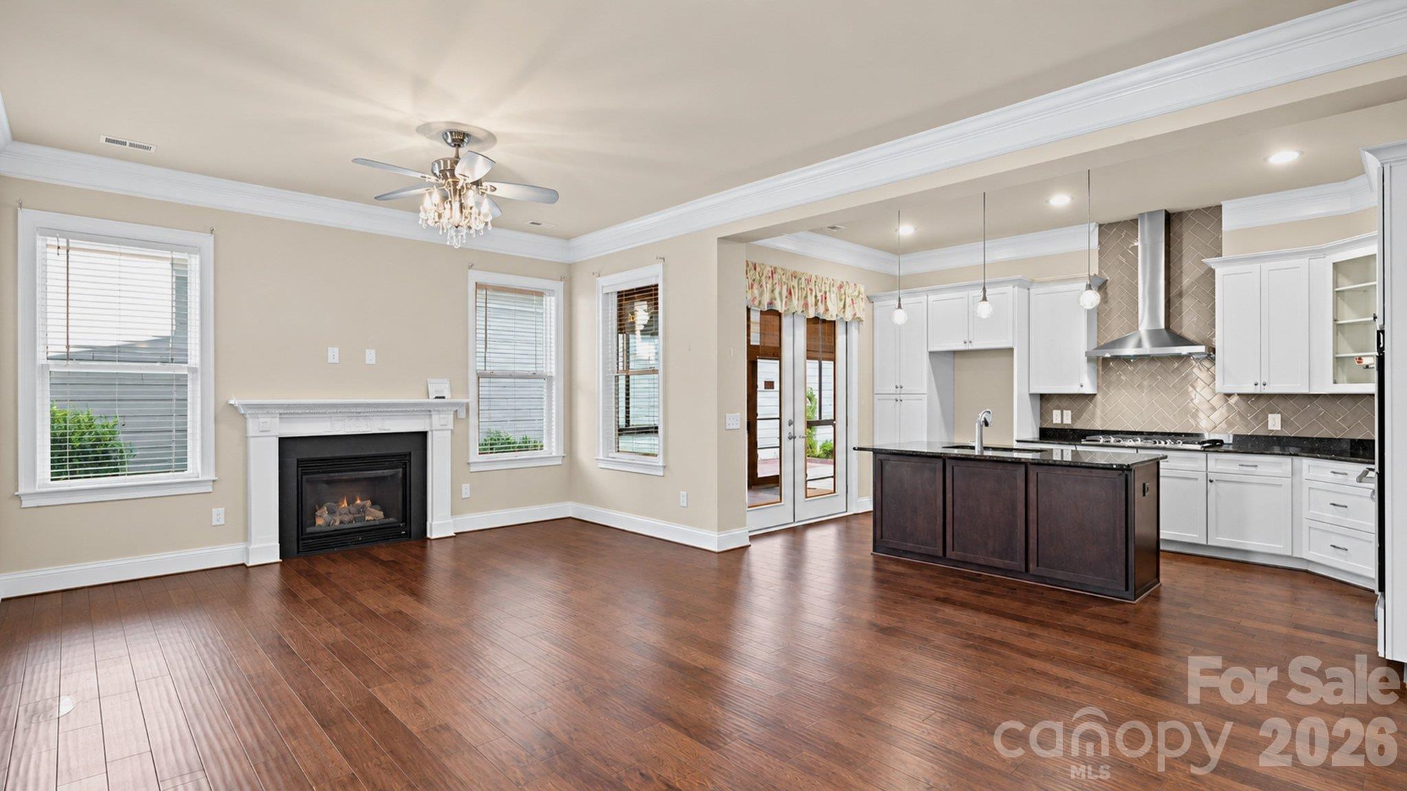Open great room with fireplace flowing into the kitchen - 2050 Laney Pond Road, Matthews