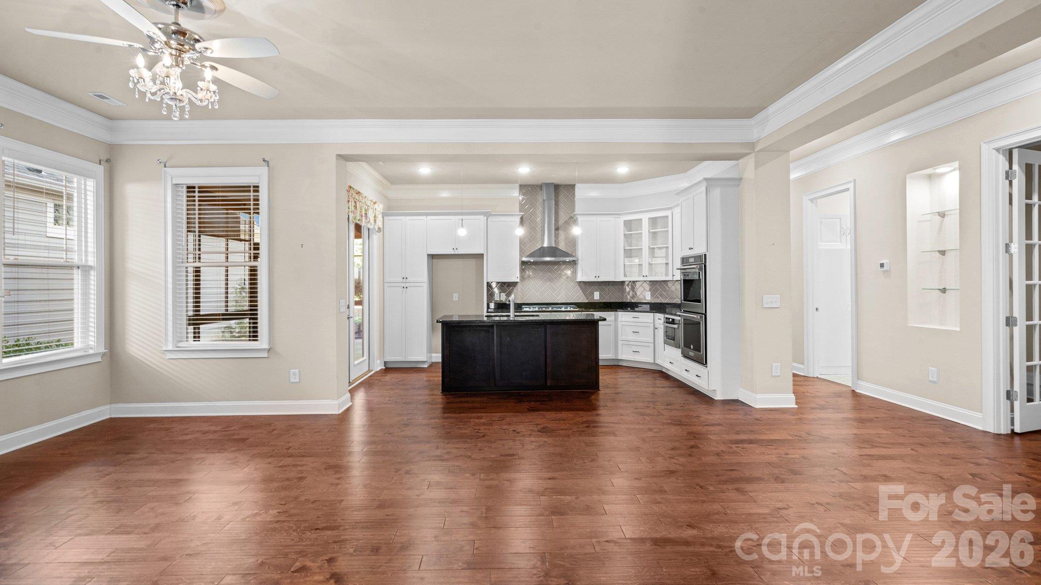 Open-concept living with hardwood floors and crown molding - 2050 Laney Pond Road, Matthews