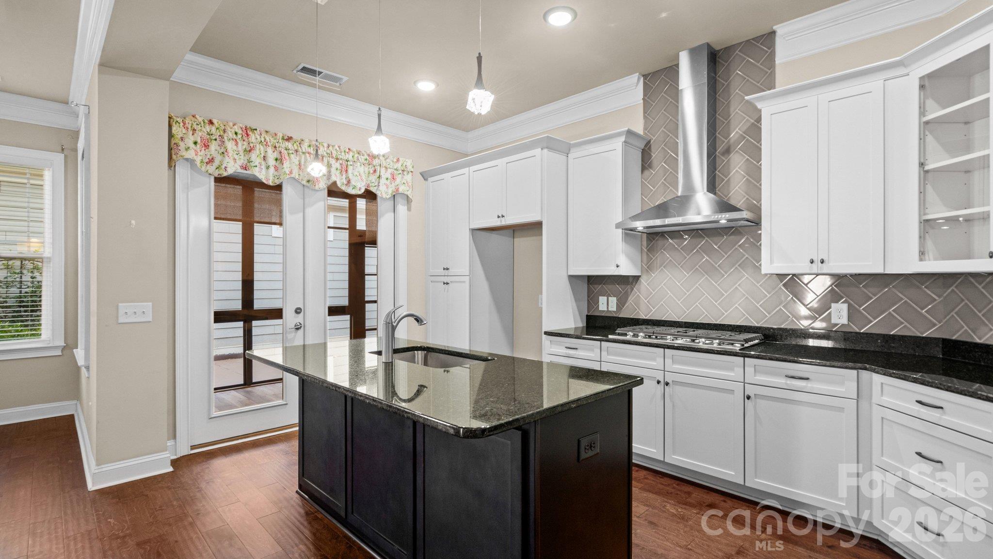 Gourmet kitchen with white cabinetry, stainless appliances and large island - 2050 Laney Pond Road, Matthews