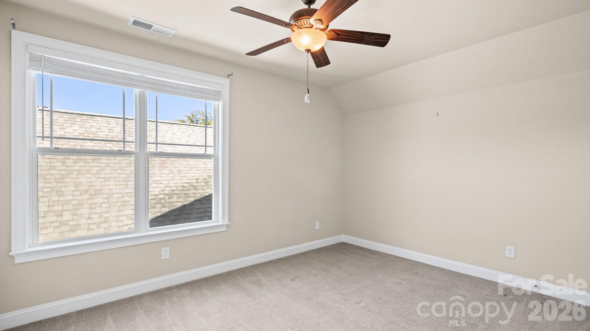 Bonus room with ceiling fan and plush carpet - 2050 Laney Pond Road, Matthews