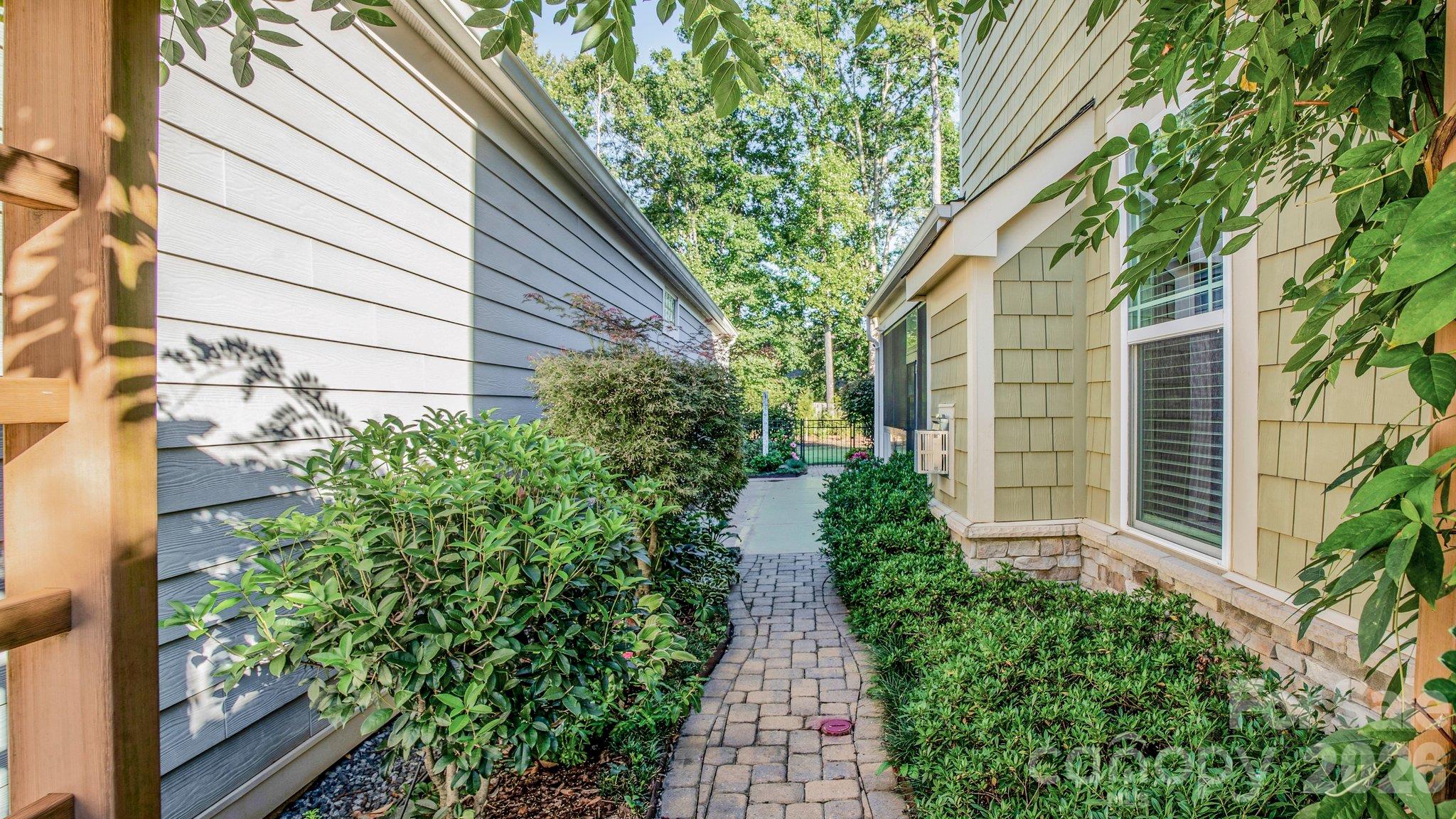 Landscaped side yard with paver walkway - 2050 Laney Pond Road, Matthews