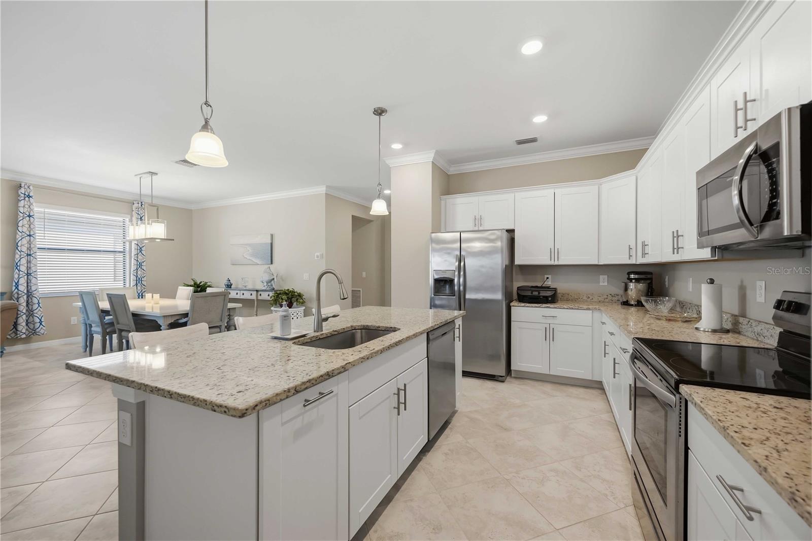 Granite counters, stainless steel appliances and white shaker cabinetry - 15945 HONEY SUCKLE ST, PORT CHARLOTTE