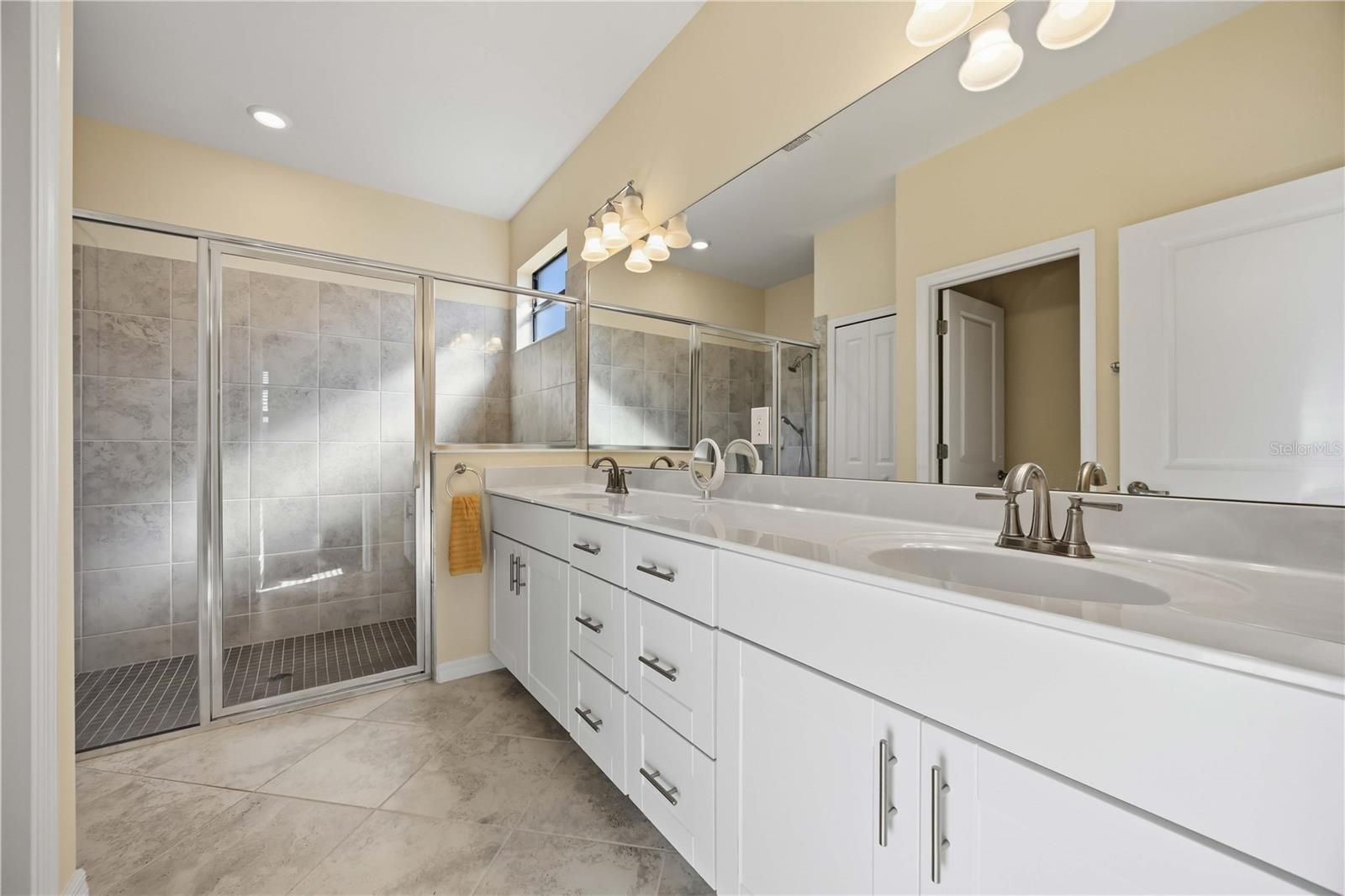 Owner's Bath with spacious tile shower and dual vanities - 15945 HONEY SUCKLE ST, PORT CHARLOTTE