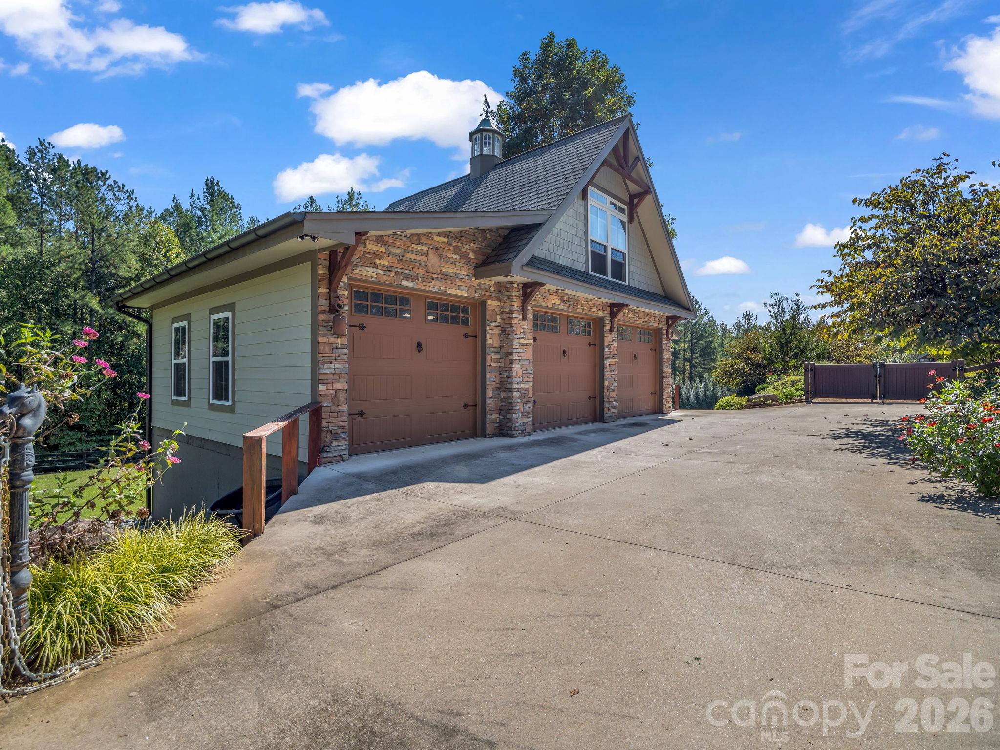 3-car detached garage with workshop space. The partial upstairs is heated and perfect for additional storage. - 140 Blazing Star Lane, Mill Spring