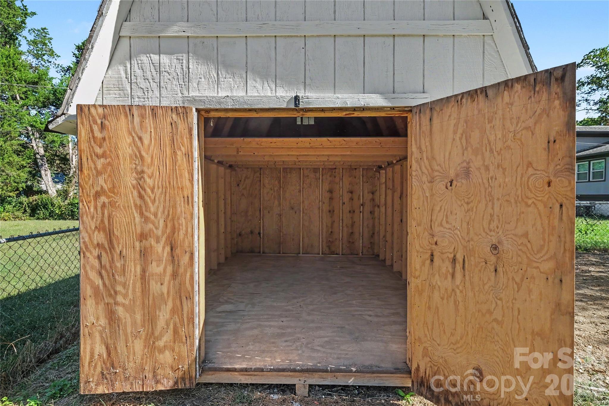 Exterior storage shed featuring lower space for a lawnmower and tools, plus a convenient upper storage loft for extra items. 11'10 " X 9'11" - 3801 Hillock Court, Charlotte