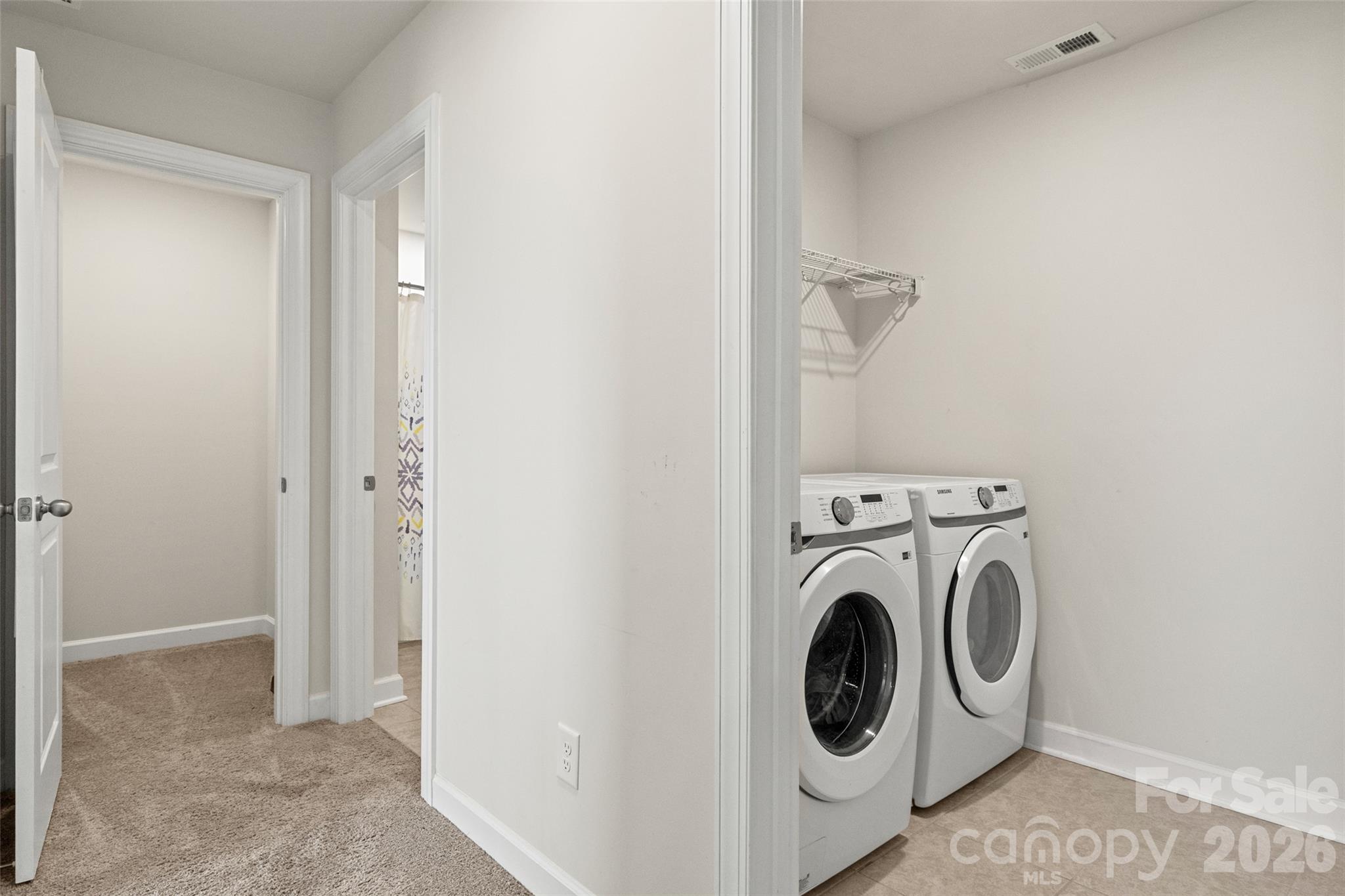 Second floor hallway featuring laundry room and large storage closet - 333 Hyssop Court, Fort Mill