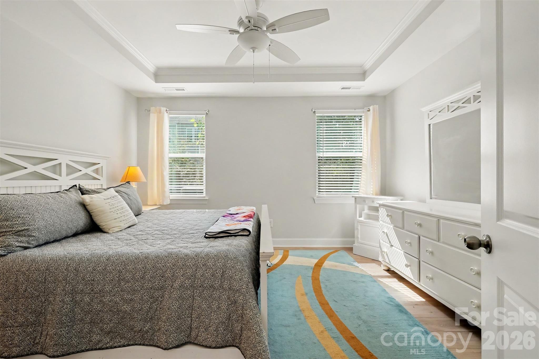 Primary bedroom with tray ceiling on the main level. - 4159 Black Court, Harrisburg
