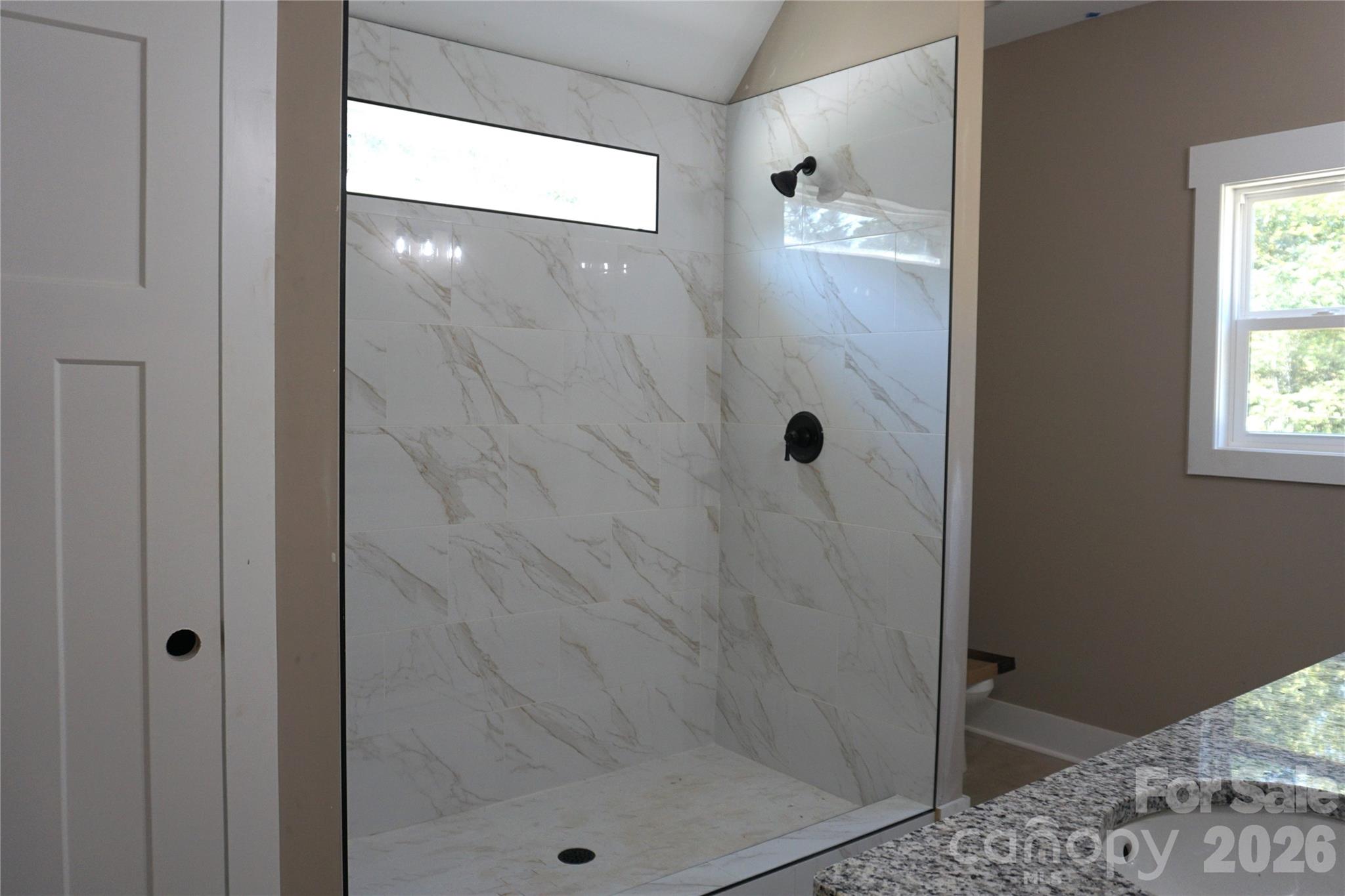 Large primary bath features walk-in shower, double sink vanity and linen closet. - 989 Rhyne Road, Clover
