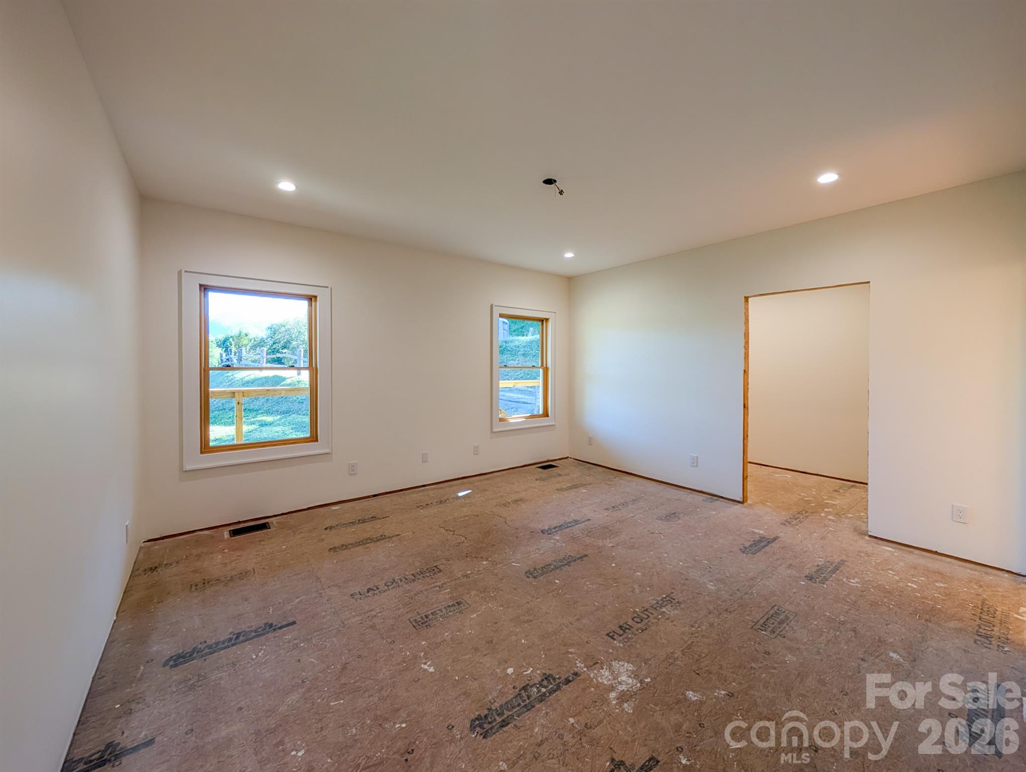 Primary Bedroom on Main level is ready for flooring includes large walk-in closet, gorgeous mountain views and  full private spacious ensuite bathroom! - 338 Majestic Mountain Drive, Burnsville