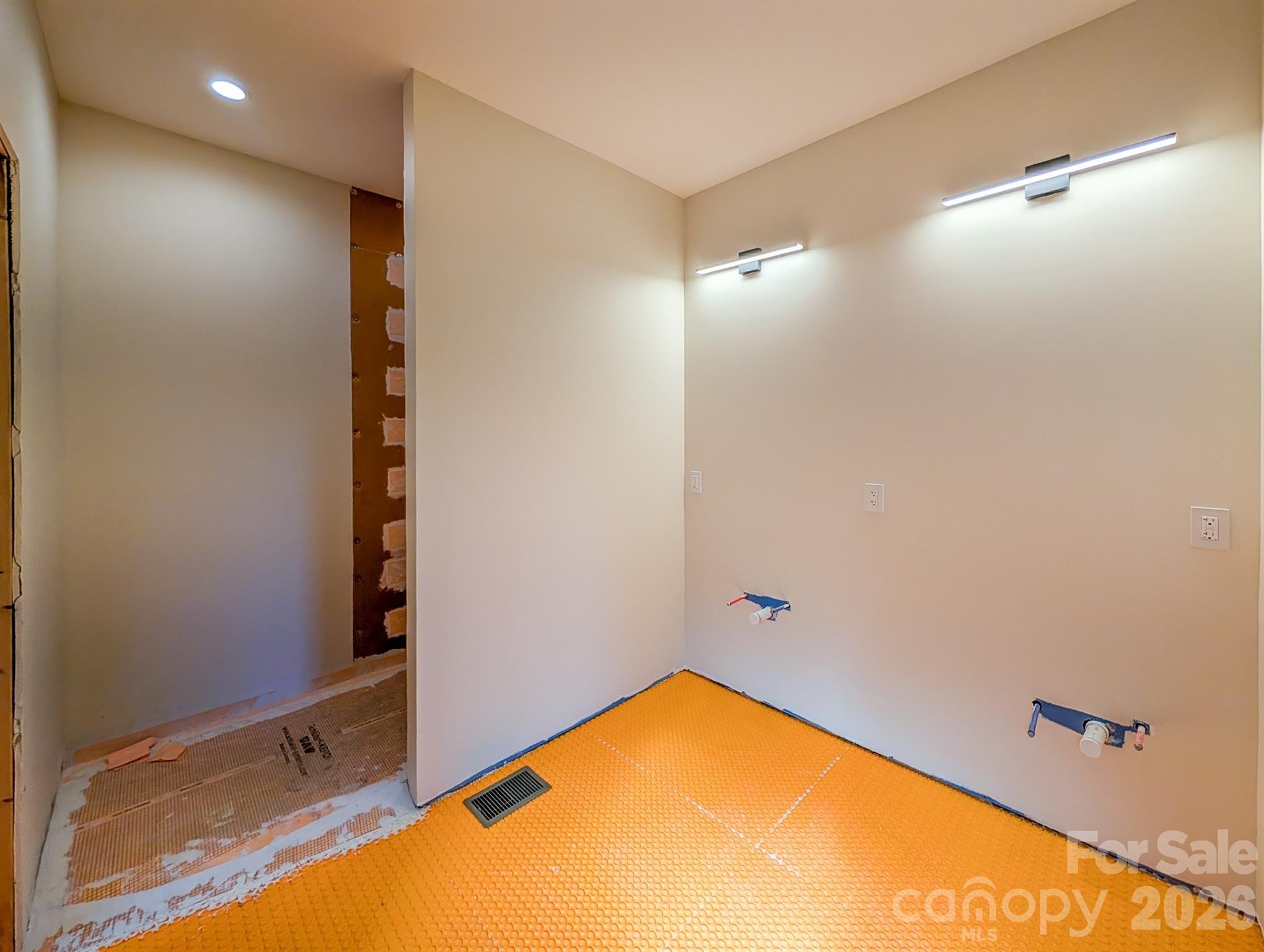 Main Level Primary Bathroom ready for flooring & double vanity. Complete with Large Walk-In Shower, closet and area for future soaking tub! - 338 Majestic Mountain Drive, Burnsville