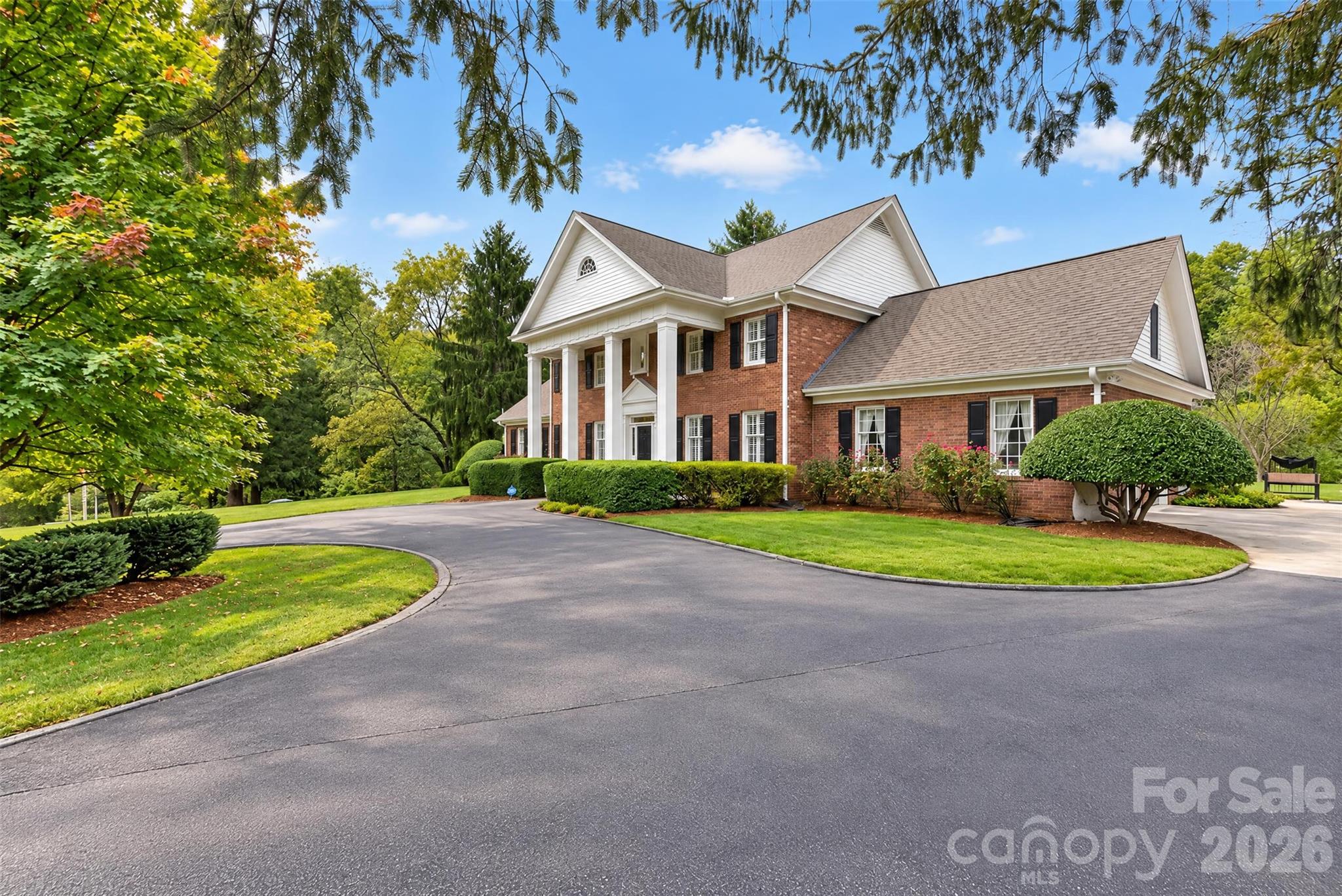 Circle driveway meets concrete driveway to garages. - 2715 Brevard Road, Hendersonville