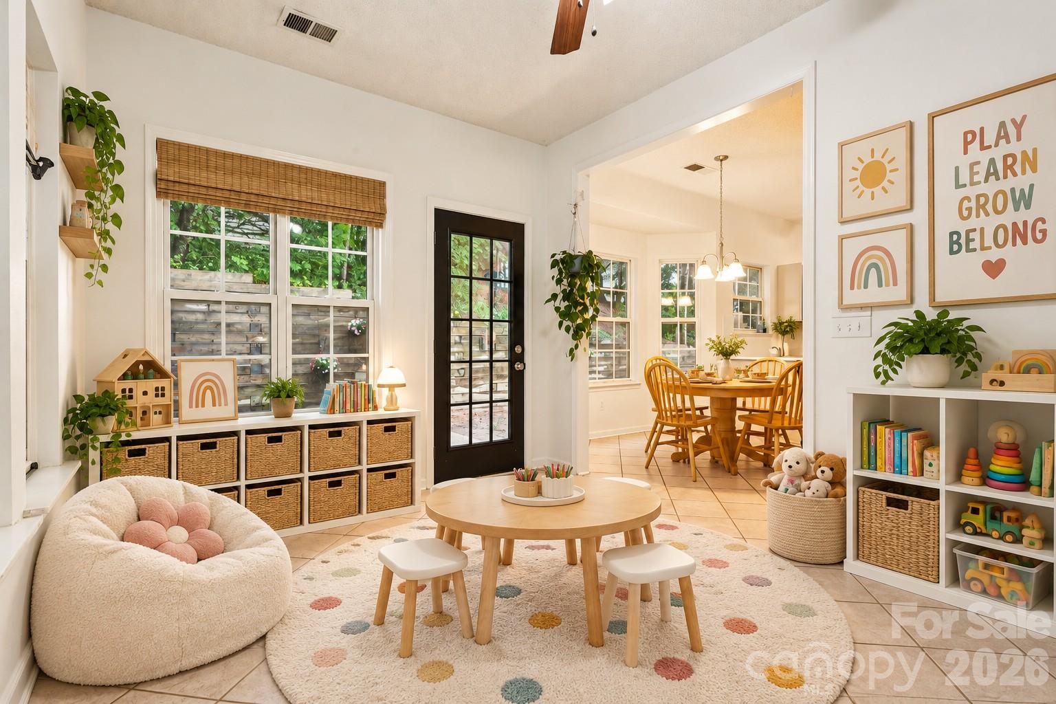 sunroom off kitchen virtually staged as a playroom - 5645 Winslow Avenue NW, Concord