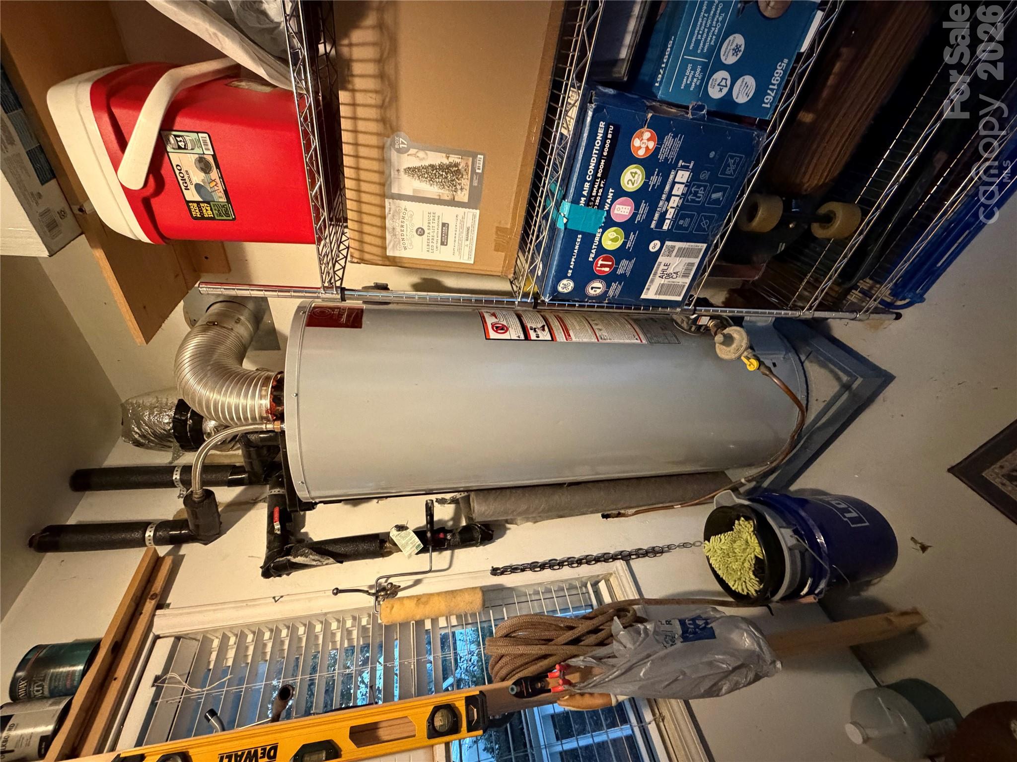 Water heater in storage room attached to the house. - 4126 Medford Drive NW, Concord