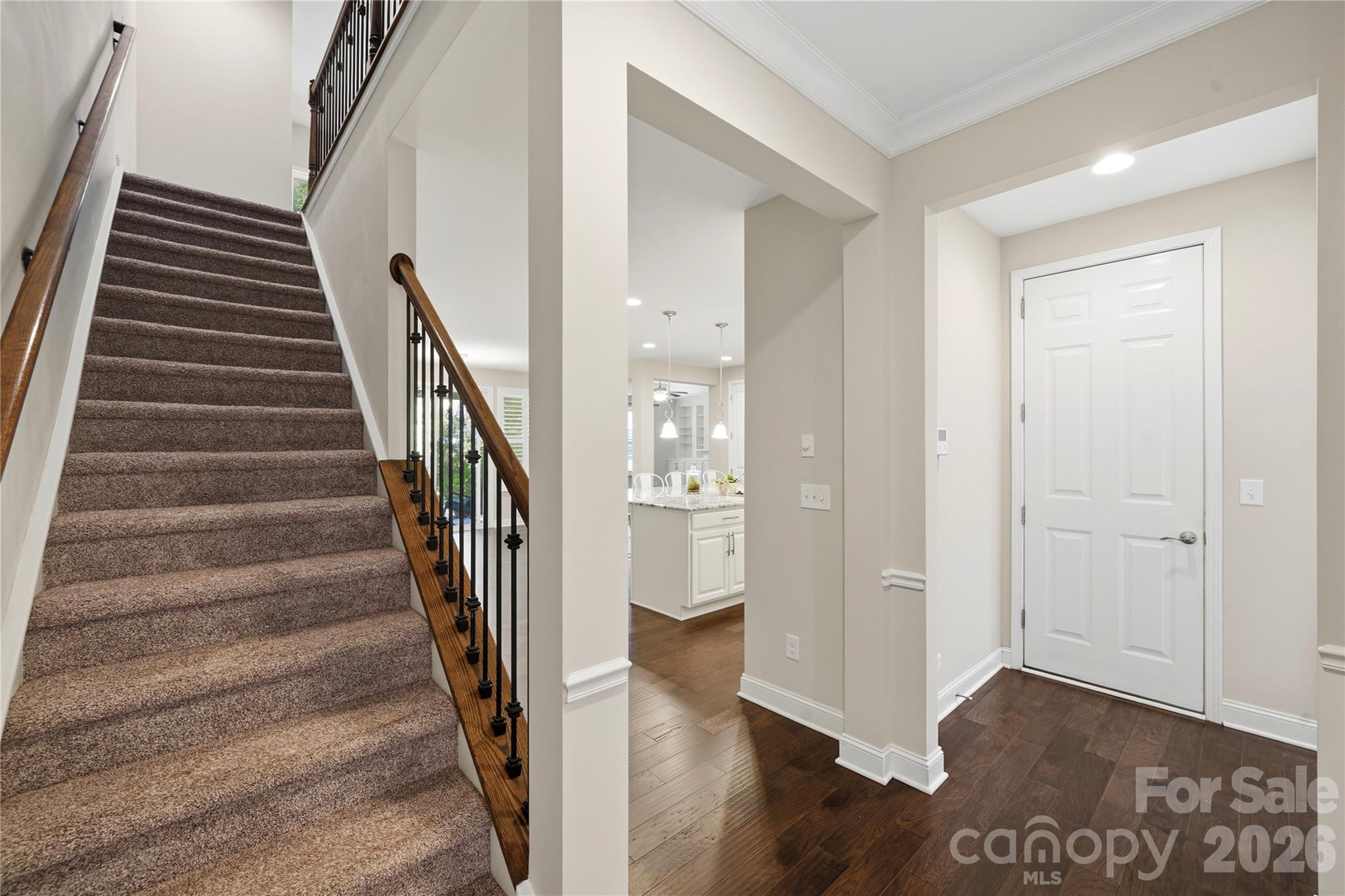 Open rod iron rails lead to the Large Loft on the upper level - 8719 Shadetree Street, Huntersville