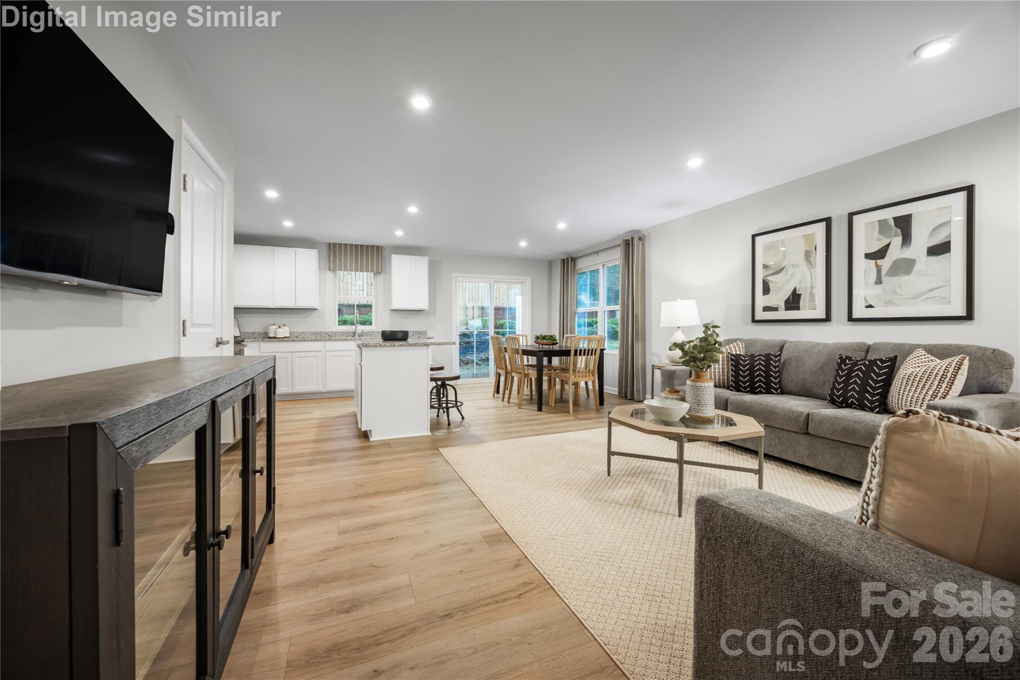 Open, inviting, and effortlessly connected—this Great Room blends kitchen, dining, and living spaces for seamless everyday comfort and entertaining. - 5219 Macvittie Lane, Charlotte