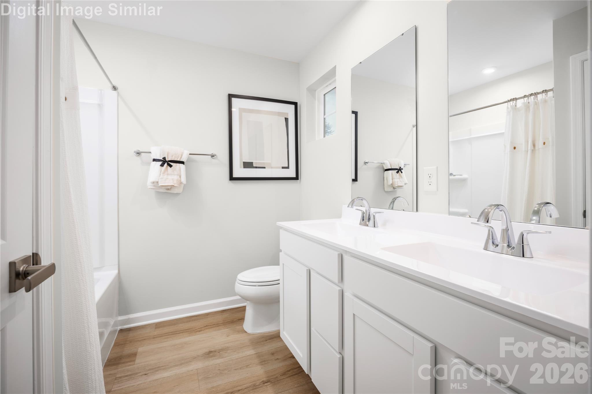 Relax and recharge in this spa-inspired owner’s bath—featuring dual ceramic sinks, generous space, and thoughtful storage for everyday luxury. - 5219 Macvittie Lane, Charlotte