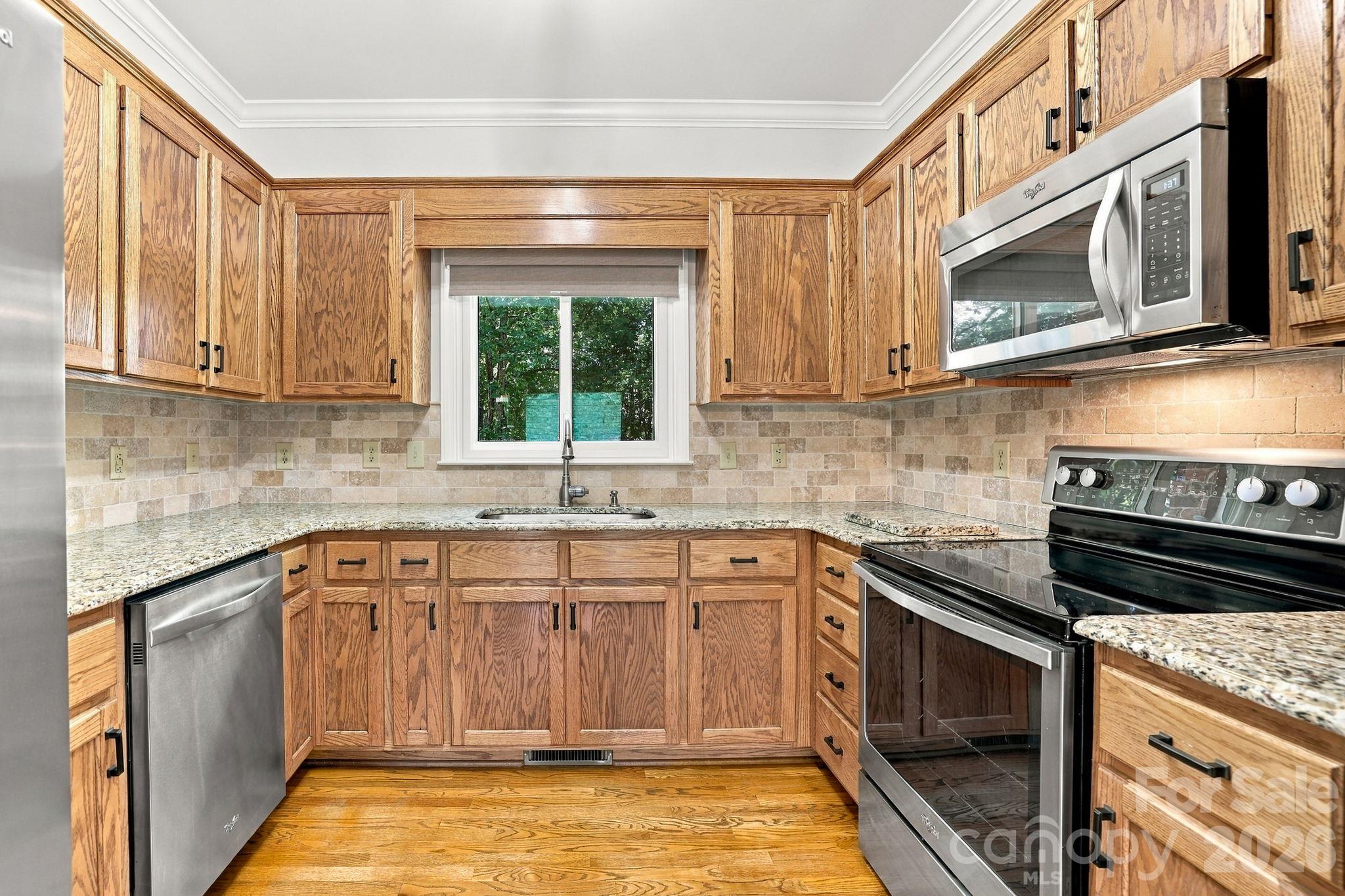 Kitchen with Granite and Stainless Steel Appliances 1471 Porch Swing Lane Matthews, NC 28104 - 1471 Porch Swing Lane, Matthews