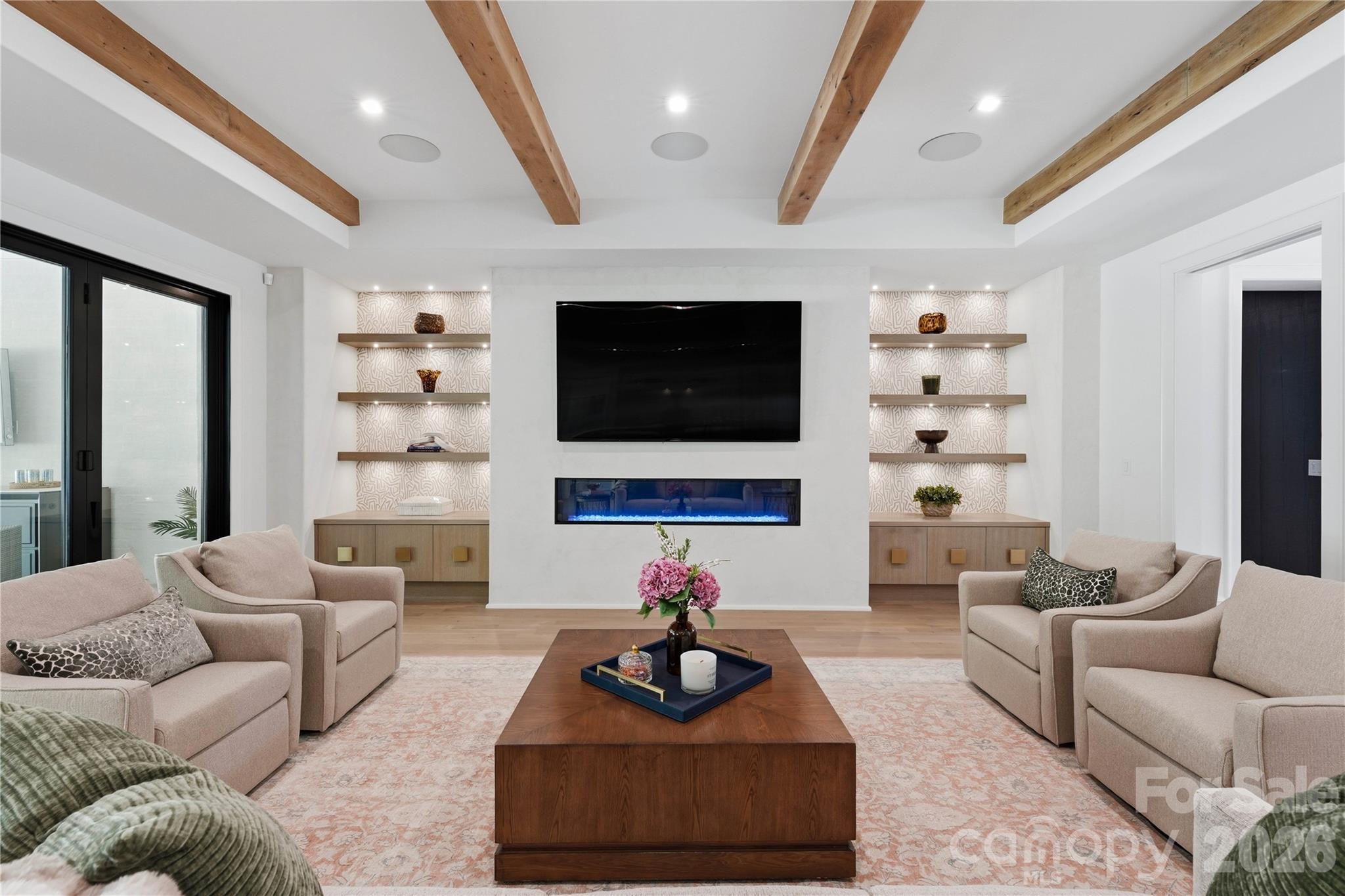 Living room with lighted floating shelves and 72 inch gas fireplace. - 2610 Sedley Road, Charlotte