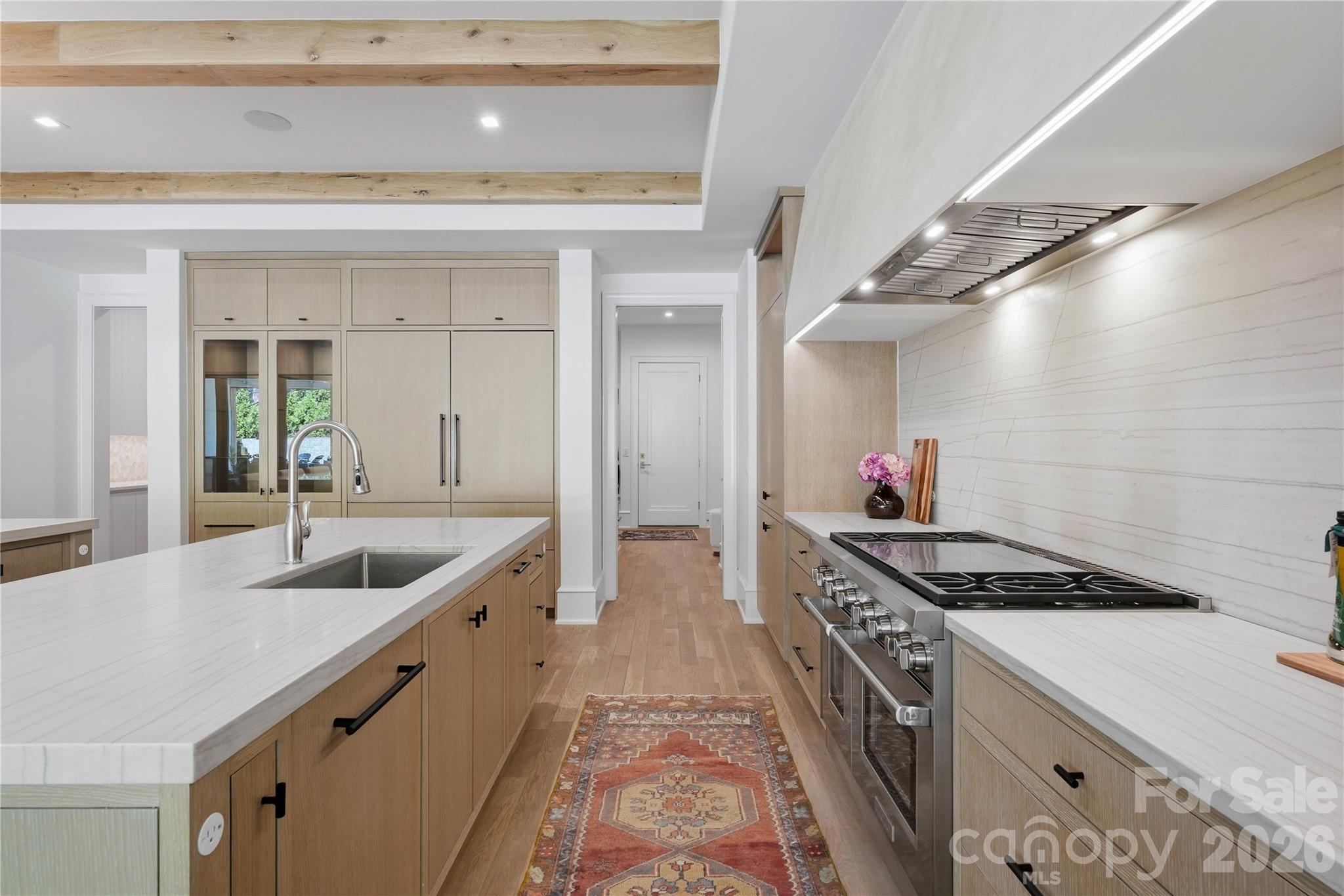 Kitchen features a 48" Wolf gas range and honed quartzite countertops. - 2610 Sedley Road, Charlotte