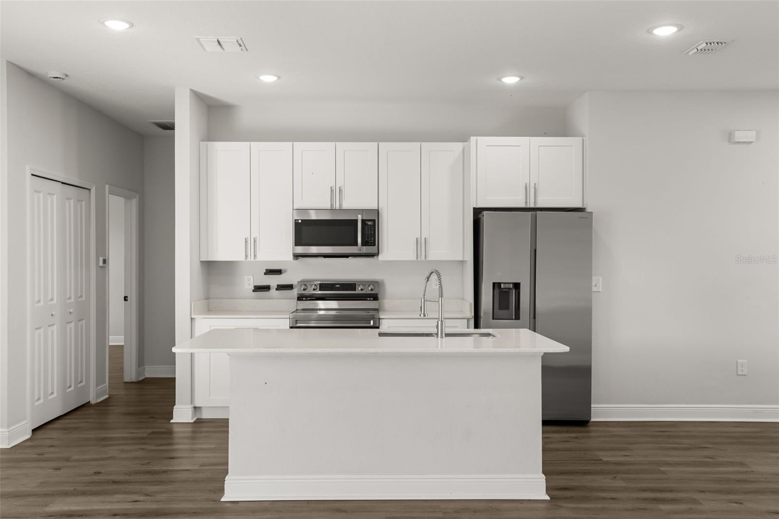 Kitchen comes with stainless steel appliances and an island - 1101 SAINT TROPEZ CT, KISSIMMEE
