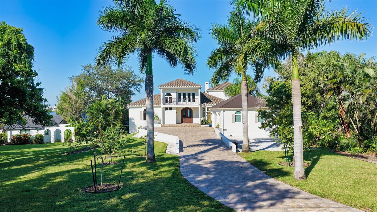 Looking at the property from the private road, fruit trees line the paved driveway - 2115 LYCHEE LN, NOKOMIS