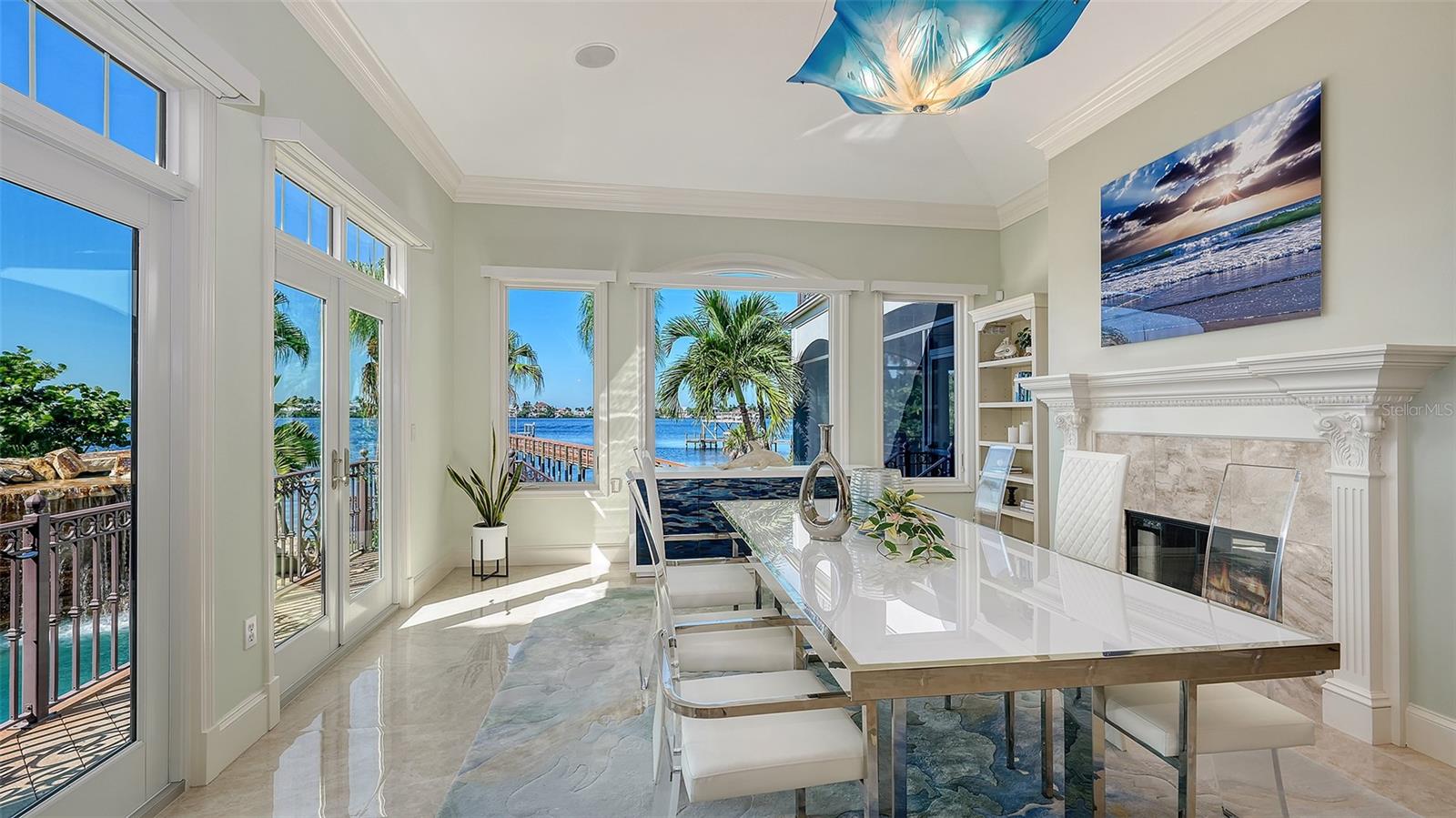formal dining room with walls of windows to the water - 2115 LYCHEE LN, NOKOMIS